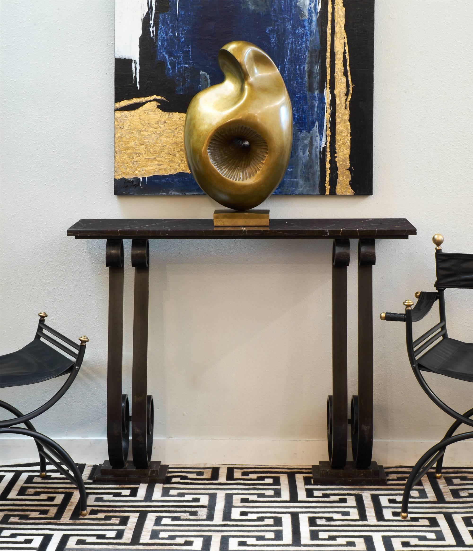 French Art Deco forged iron console table with beautiful black marble top flowing with white and amber striations. Sophisticated and bold base design with fantastic proportions, this sculptural table almost is a true work of art.