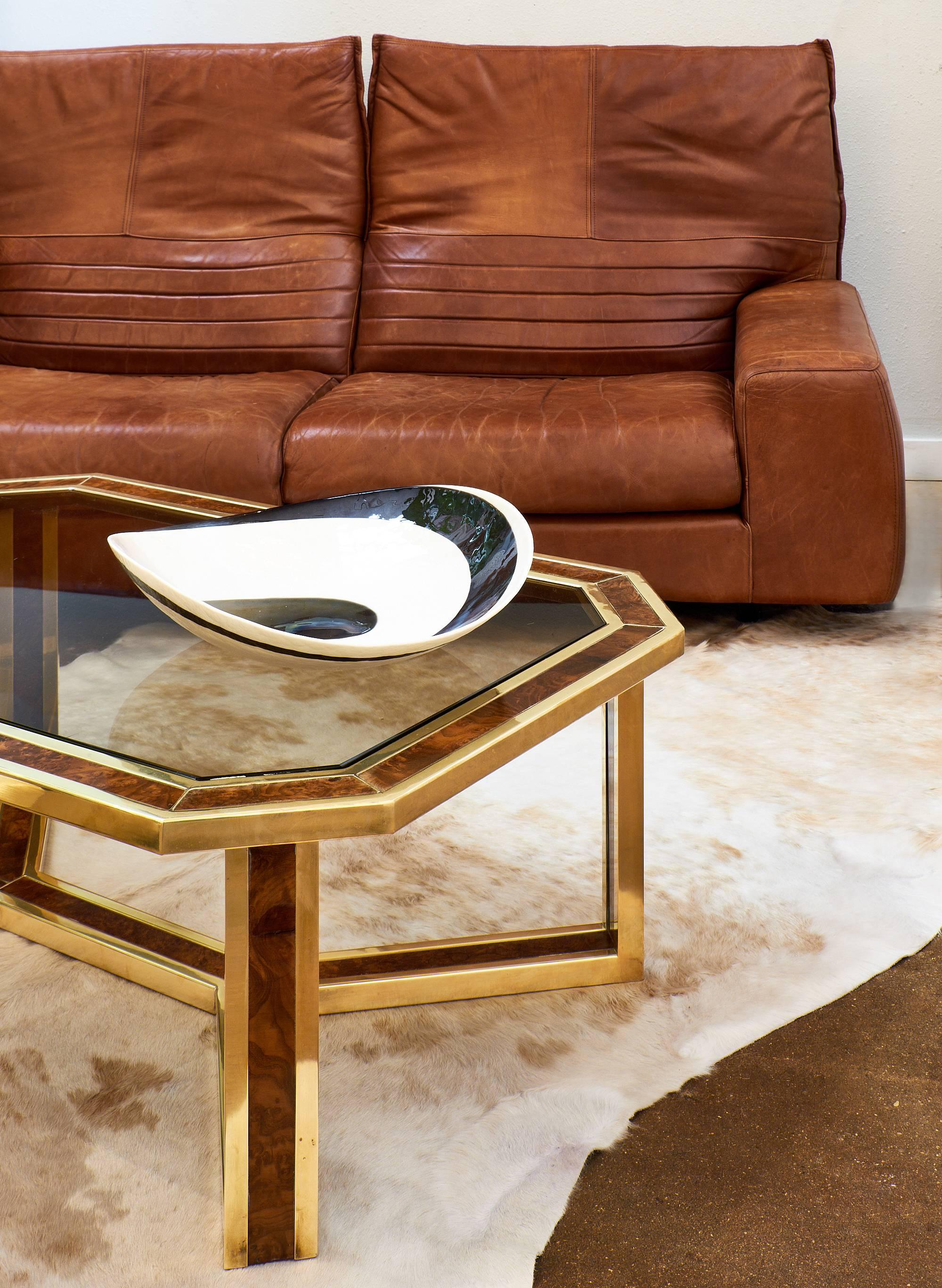 Wonderful Mid-Century Modern coffee table with a solid gilded brass and burled ash frame. This piece is very warm and elegant with a smoked glass top and fantastic craftsmanship. Strong design by Maison Jansen. 

 