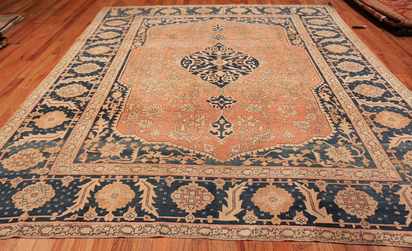 Antique Serapi carpet, origin Persia, circa 1900. Like most Serapi carpets, this piece uses an elegantly understated degree of color to allow the craftsmanship in the shapes to shine through. Bright, pale gold stands out against the deep, dark
