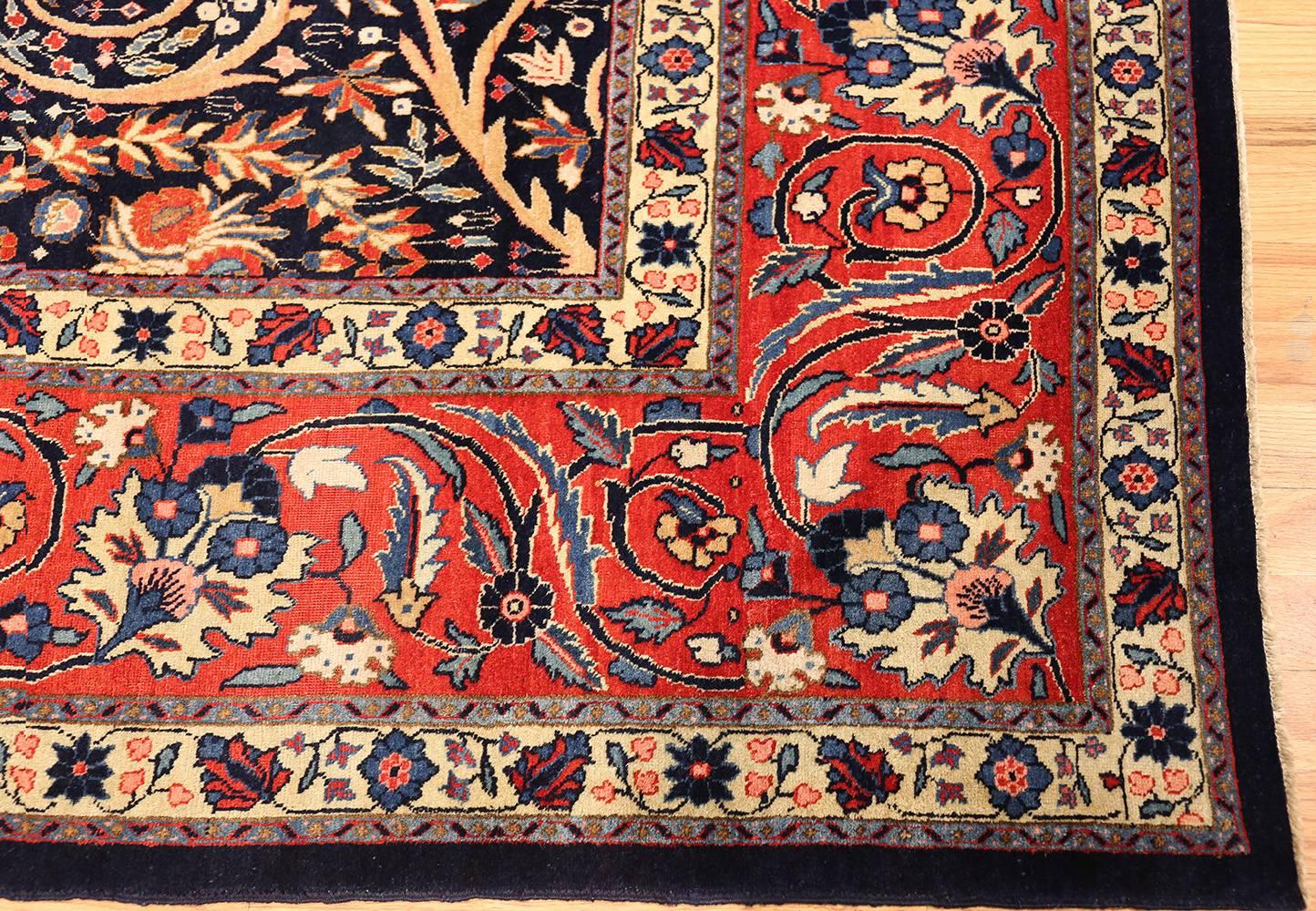 Antique Tabriz Carpet, Origin: Persia, Circa 1920. Size: 11 ft x 14 ft 3 in (3.35 m x 4.34 m)

Where many traditional Persian carpets would apply brighter, more fiery colors throughout, this ones allows the contrast between the dark and light hues