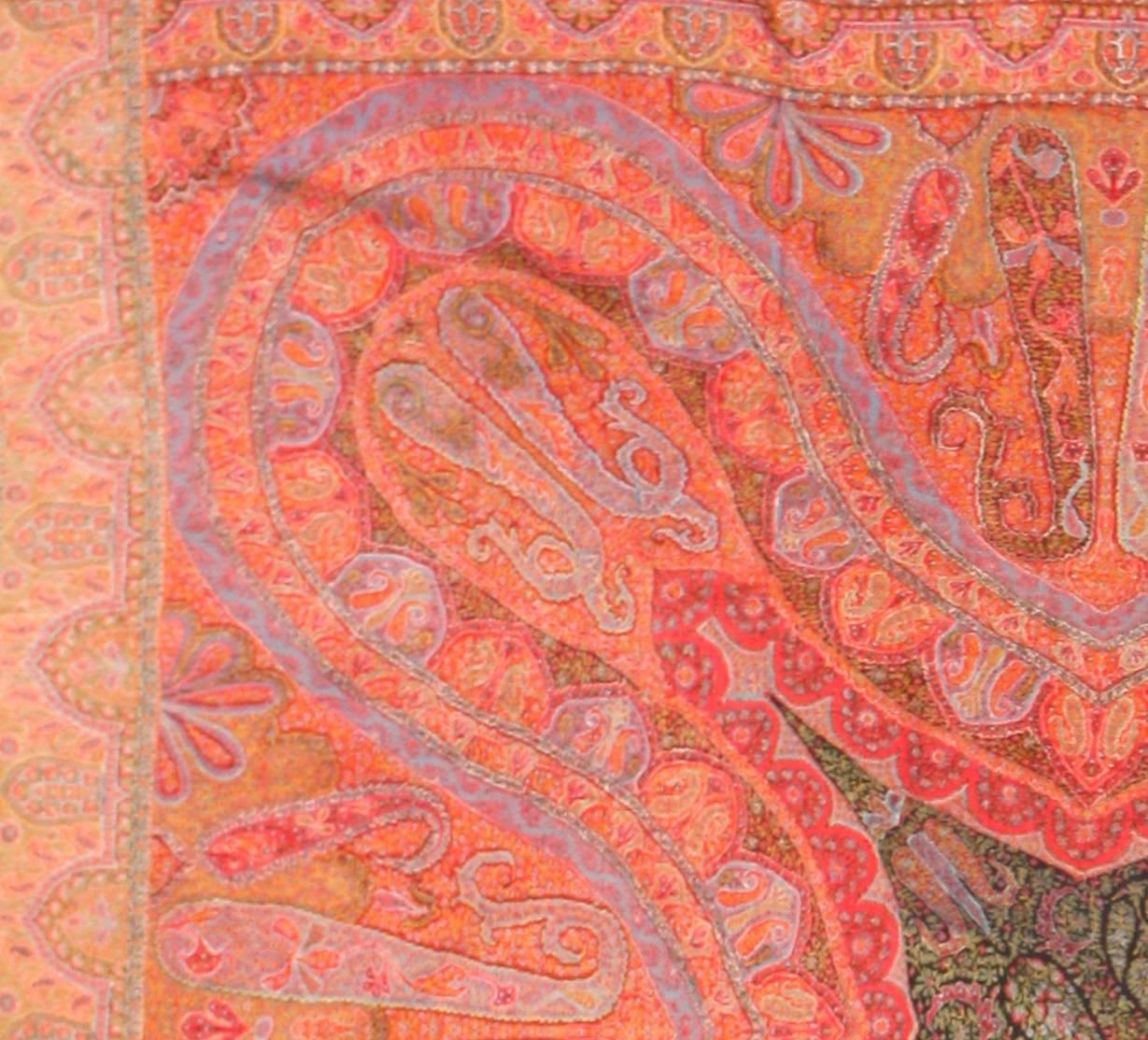 Fine antique Indian floral shawl, country of origin: India, circa date 1860. This antique shawl from India possesses a liquid beauty, with delicate details and a kaleidoscopic pattern that draws the viewer in. Produced in warm tangerine and pale