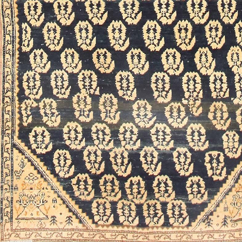 Antique Persian Malayer Runner Rug, Country of Origin: Persia, Circa Date: 1920– A large diamond medallion nestles at the center of this lengthy antique Persian rug, resting against a blue-black field. The ivory and white figure is filled with a
