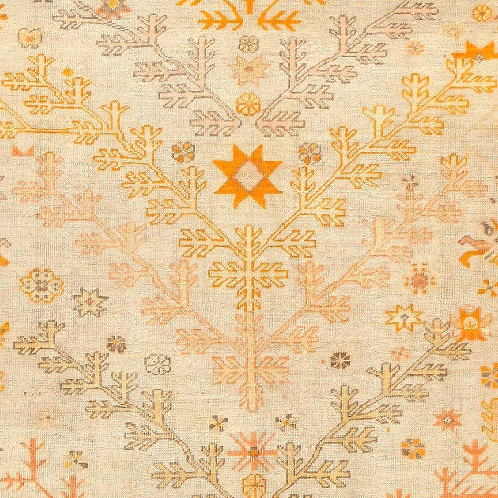 Beautiful Decorative Tree Of Life Design Antique Turkish Oushak Rug, Country of Origin / Rug Type: Antique Turkish Rug, Circa Date: 1900 – Symmetrical boughs in autumnal colors angle away from each other down the body of this antique Turkish rug.