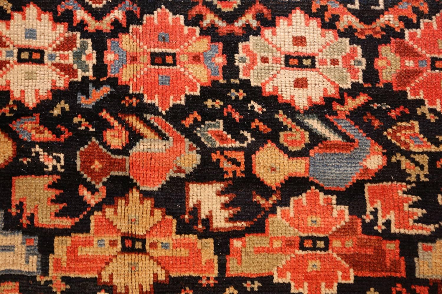 Like many other stylish antique tribal Qashqai Persian rugs, this gallery size beauty uses exquisite colors and painstaking details to create a lively and active piece of art. Several borders wraparound each other in alternating patterns of beige,