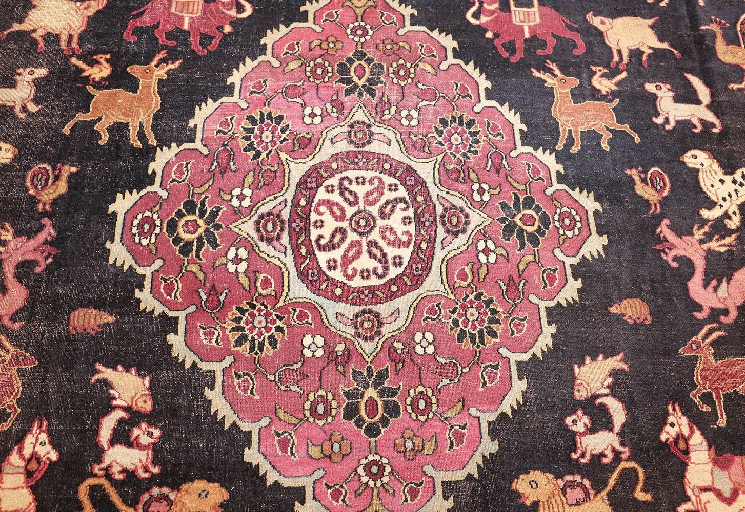Woven in the mid 19th century, this antique rug from Khorassan features a formal medallion flanked by a juxtaposed parade of exotic and mythological animals.

Antique Animal Motif Persian Khorassan Rug, Country of Origin: Persia, Circa Date: Mid