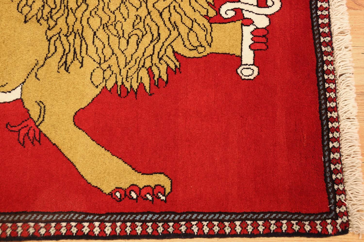 This fascinating rug from Qashqai features an armed Persian lion set against a red field, creating a commanding presence.

Vintage Persian Qashqai rug, origin: Persia, circa mid-20th century. Here is an absolutely intriguing antique Persian rug, a
