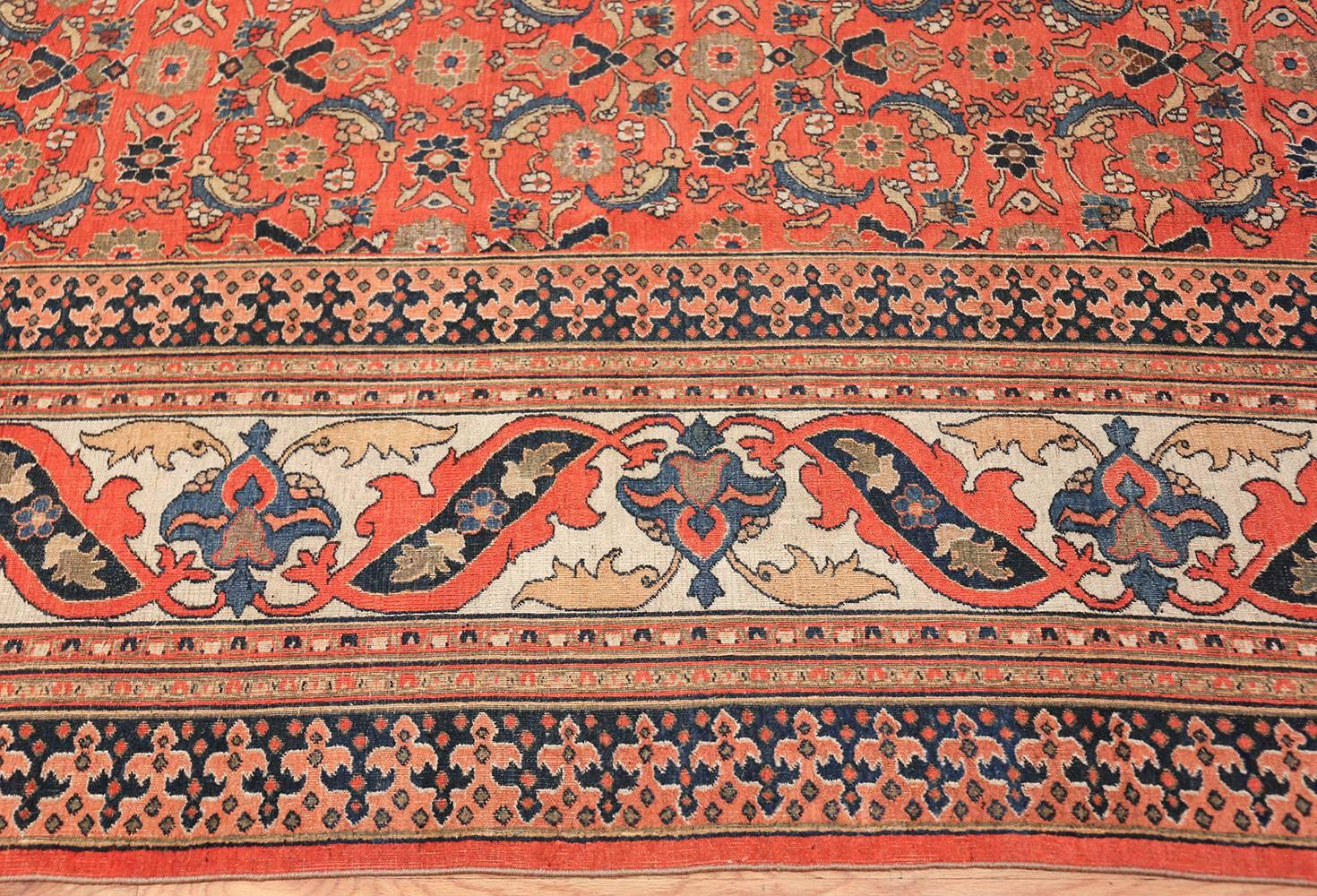 Antique Persian Khorassan Carpet, Circa Early 20th Century — Size: 9 ft 10 in x 13 ft 9 in (3 m x 4.19 m)

The foundation of this bold Khorassan carpet is a deep, sophisticated red, a color that fittingly denotes both warmth and strength. Strict