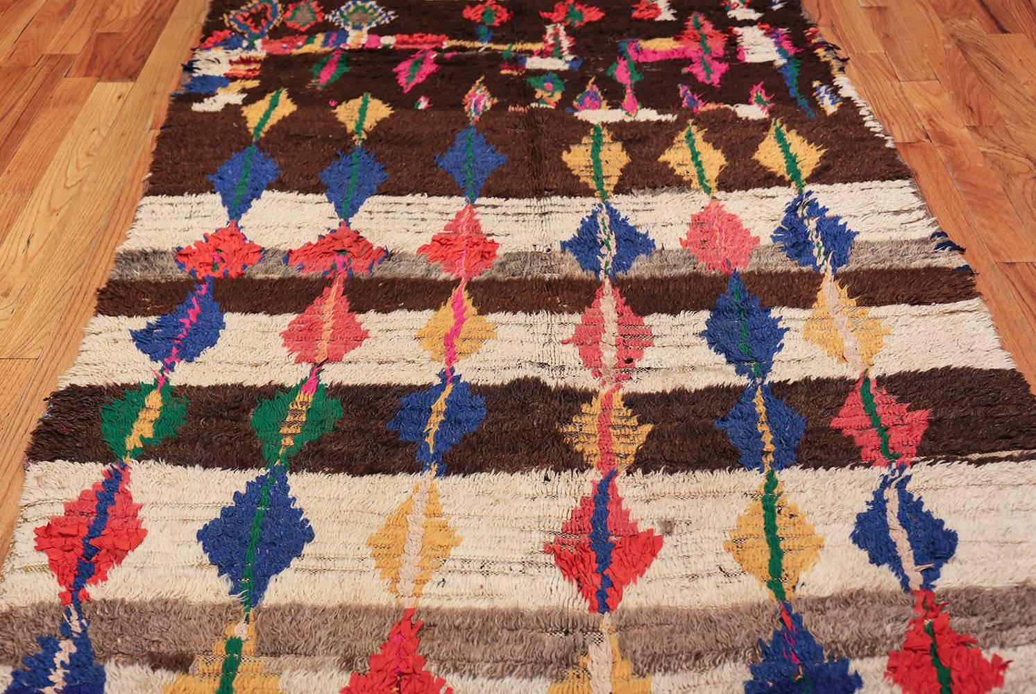 Vintage Mid Century Folk Art Moroccan Rug, Morocco, Circa: Middle Part of the 20th Century – Size: 4 ft 9 in x 10 ft 4 in (1.45 m x 3.15 m)

The use of vibrant colors alongside earthy tones creates a dimensional piece of art. Of course the mid