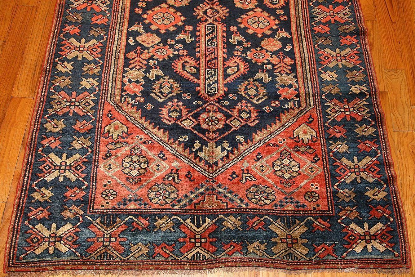 Antique Persian Malayer runner rug, country of origin: Persia, date circa 1920. This antique Persian rug, a Malayer runner, features an extremely bold personality that grabs the attention of the viewer with its strength and charm. With brilliant,
