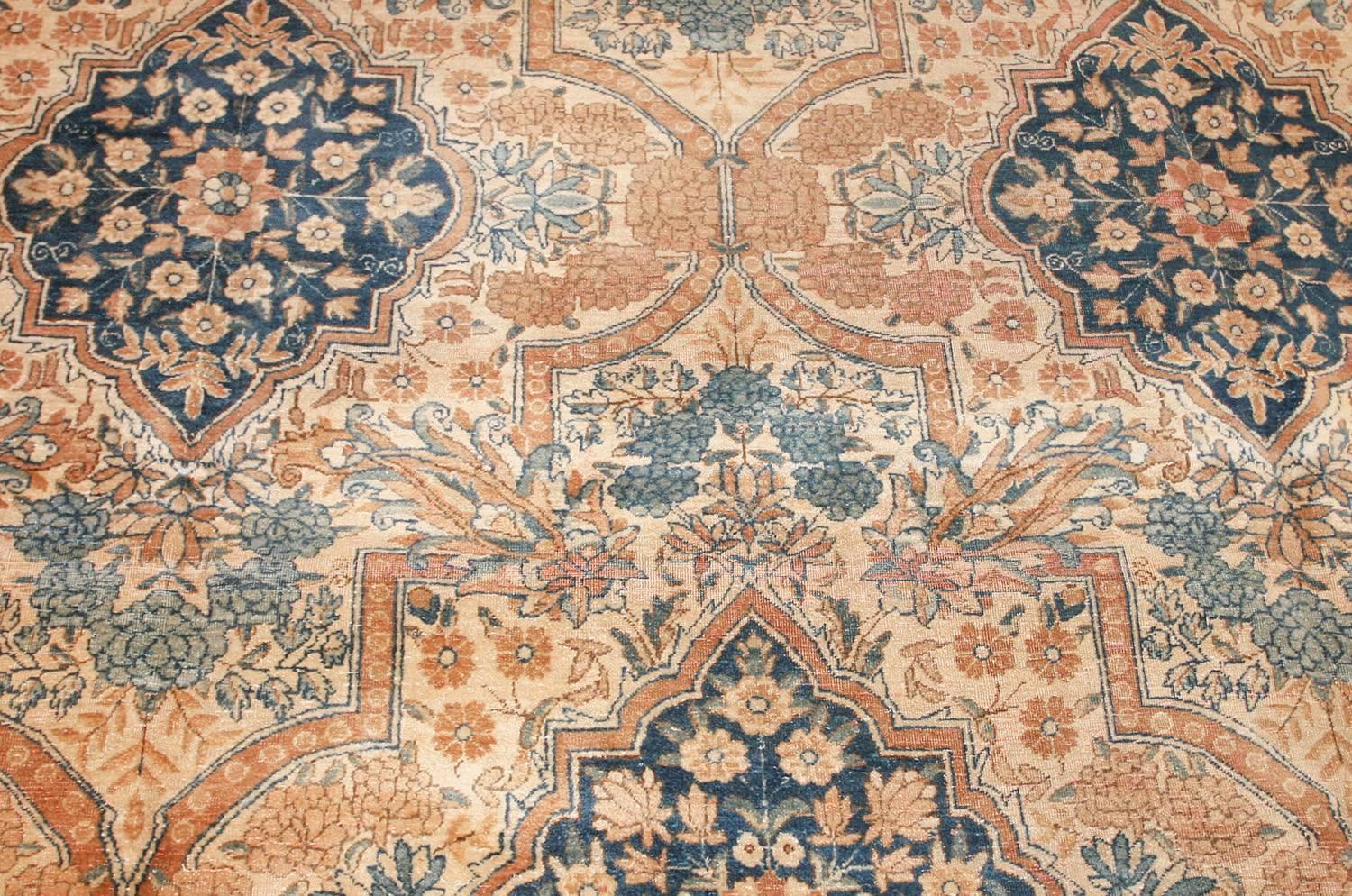 Antique Persian Kerman Rug, Country of Origin: Persia, Circa Date: Early 20th Century.  Size: 10 ft 6 in x 14 ft 2 in (3.2 m x 4.32 m) 

Floral garlands, wreaths and arching swags featuring Kerman’s precisely shaded carnation blossoms decorate this