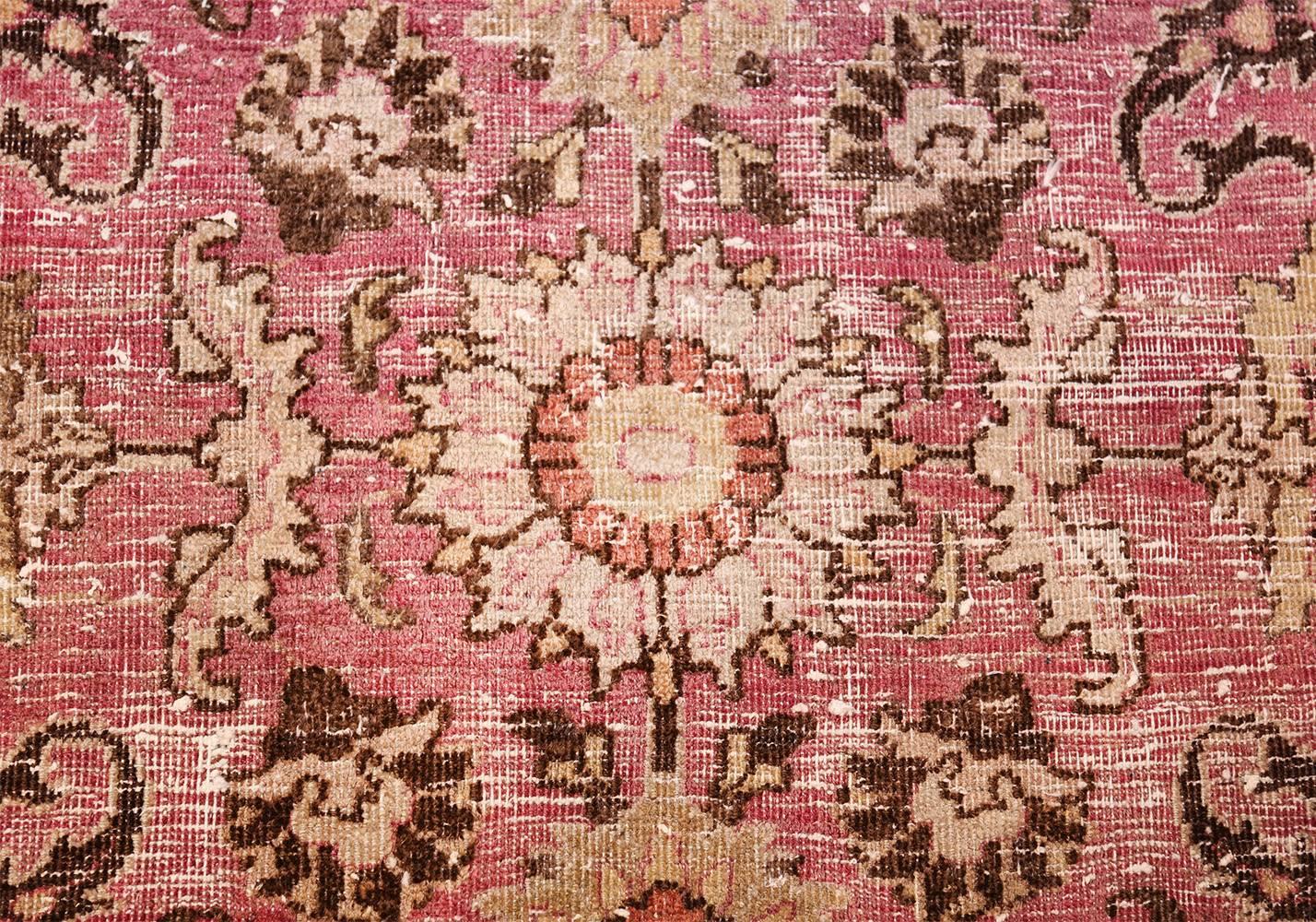 Antique Persian Khorassan rug, Persia, circa 1920. This shabby chic antique Khorassan carpet embodies the delicate, wild loveliness of a lush garden. Pale crimson and earthy shades of cream and brown comprise the main color scheme of this striking