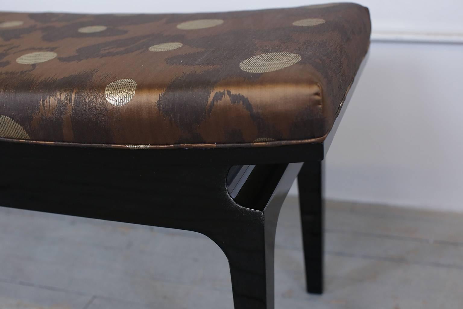 Mid-Century Modern Asiatic bench. Black lacquer. Seat newly upholstered in vintage J. Lenor Larsen fabric.