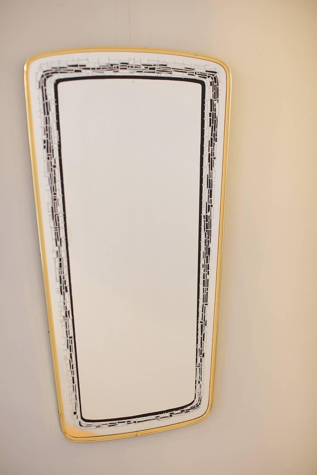 Églomisé mirror with brass frame.