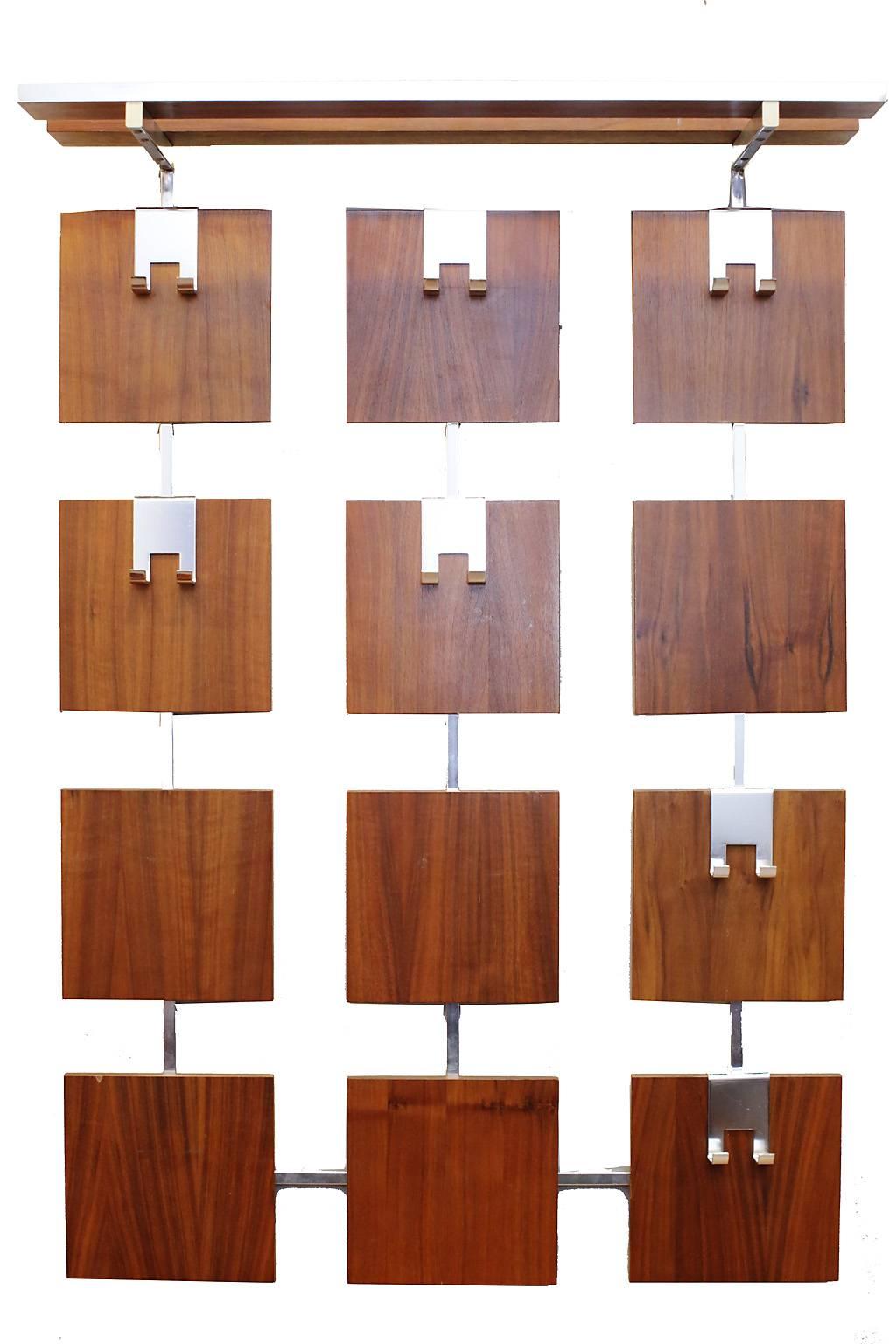 Wall mount coat rack with movable aluminium hooks on walnut blocks. Top shelf for hats.