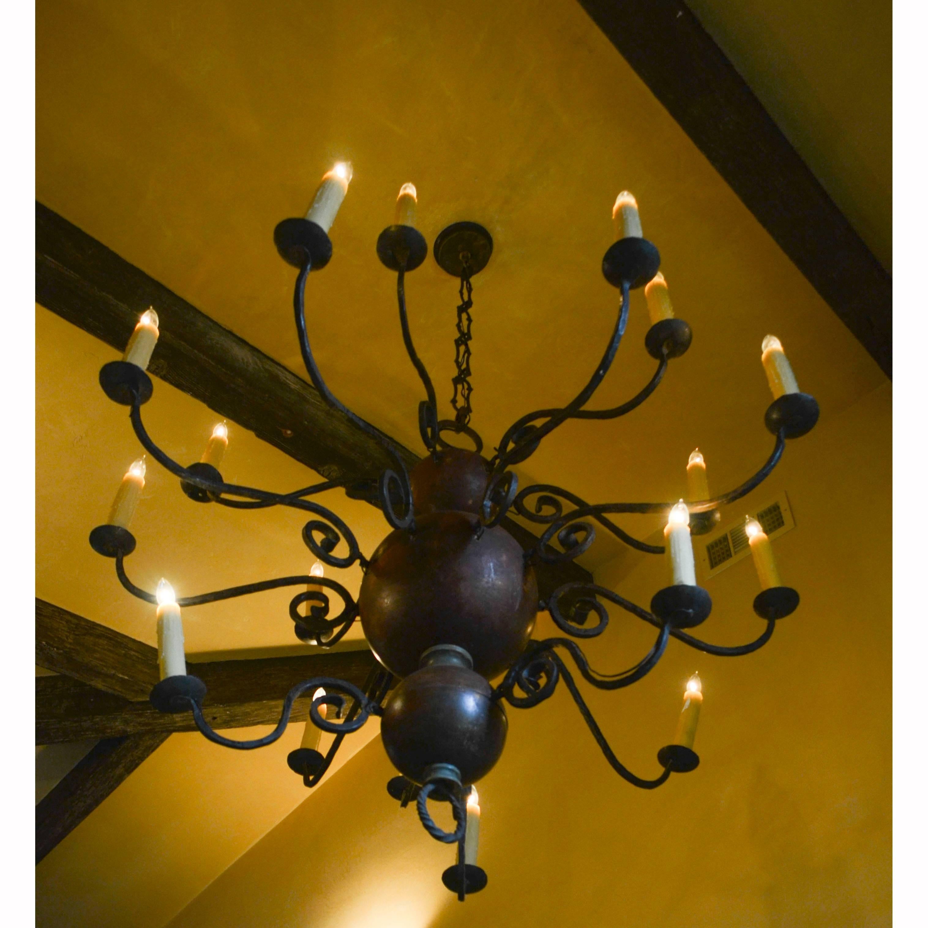 Dutch iron and wood Baroque style chandelier. Electrified, with 17 candle lamps. Wrought iron with painted spheres.