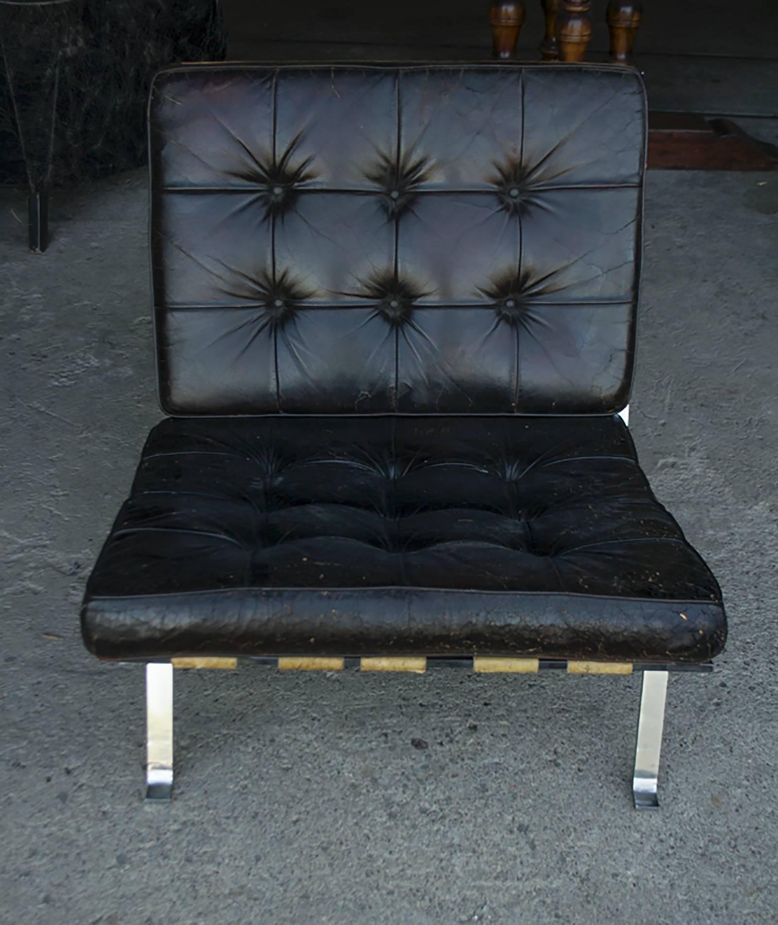 Vintage black tufted leather lounge chair.