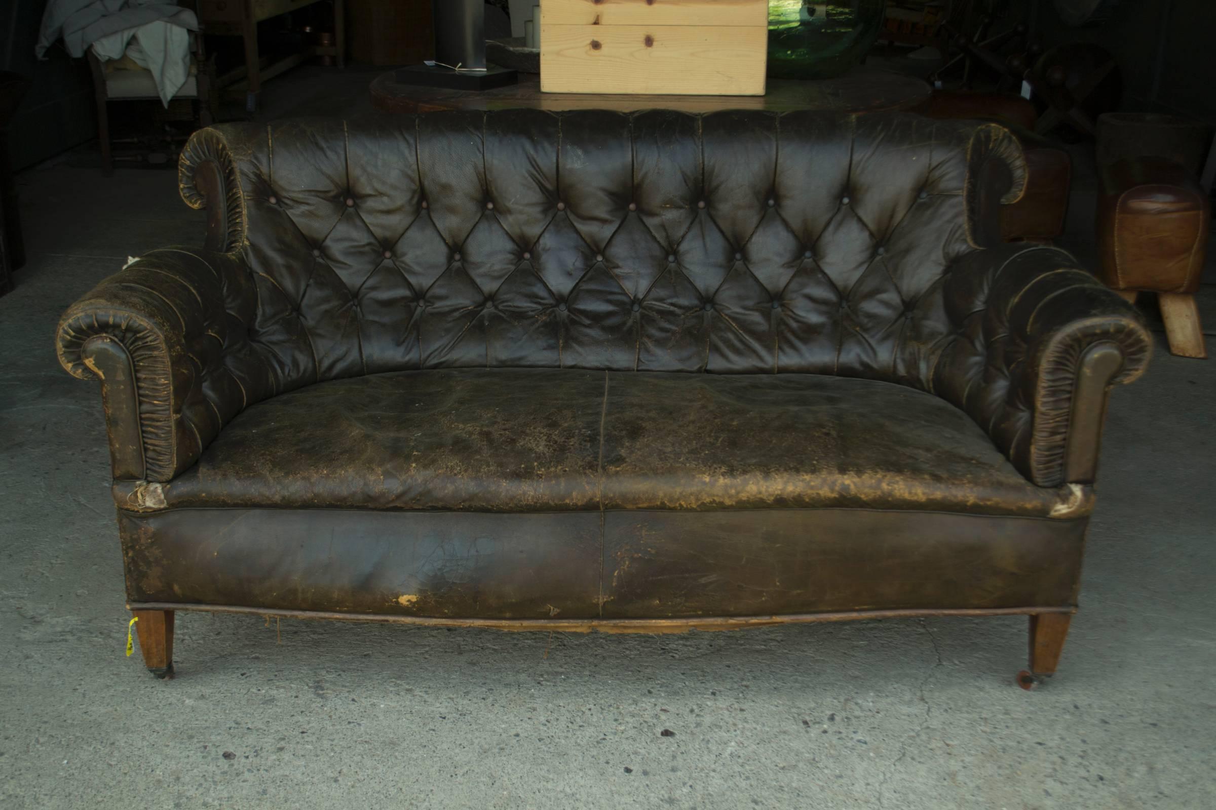 Vintage leadther Chesterfield sofa on caster. Vintage item; please see images detail of wear and tear.