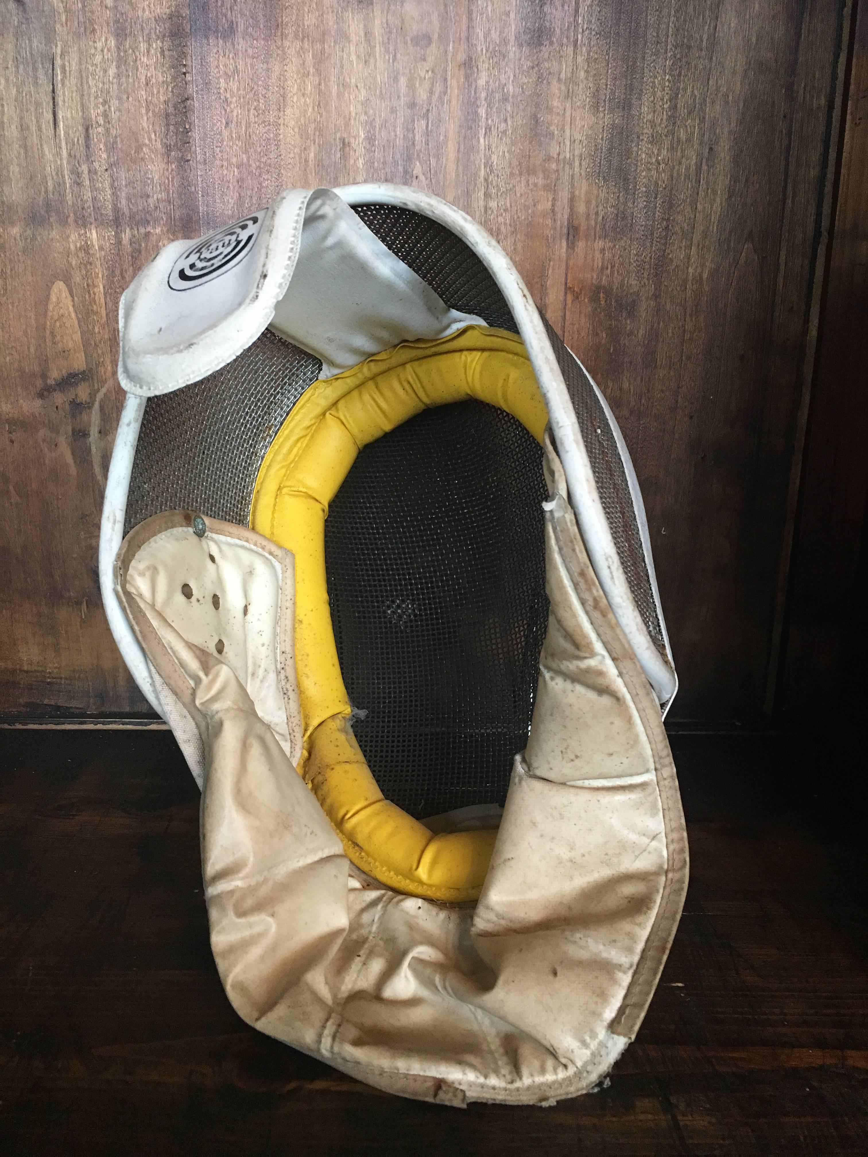 Vintage Leon Paul fencing mask with yellow head band.