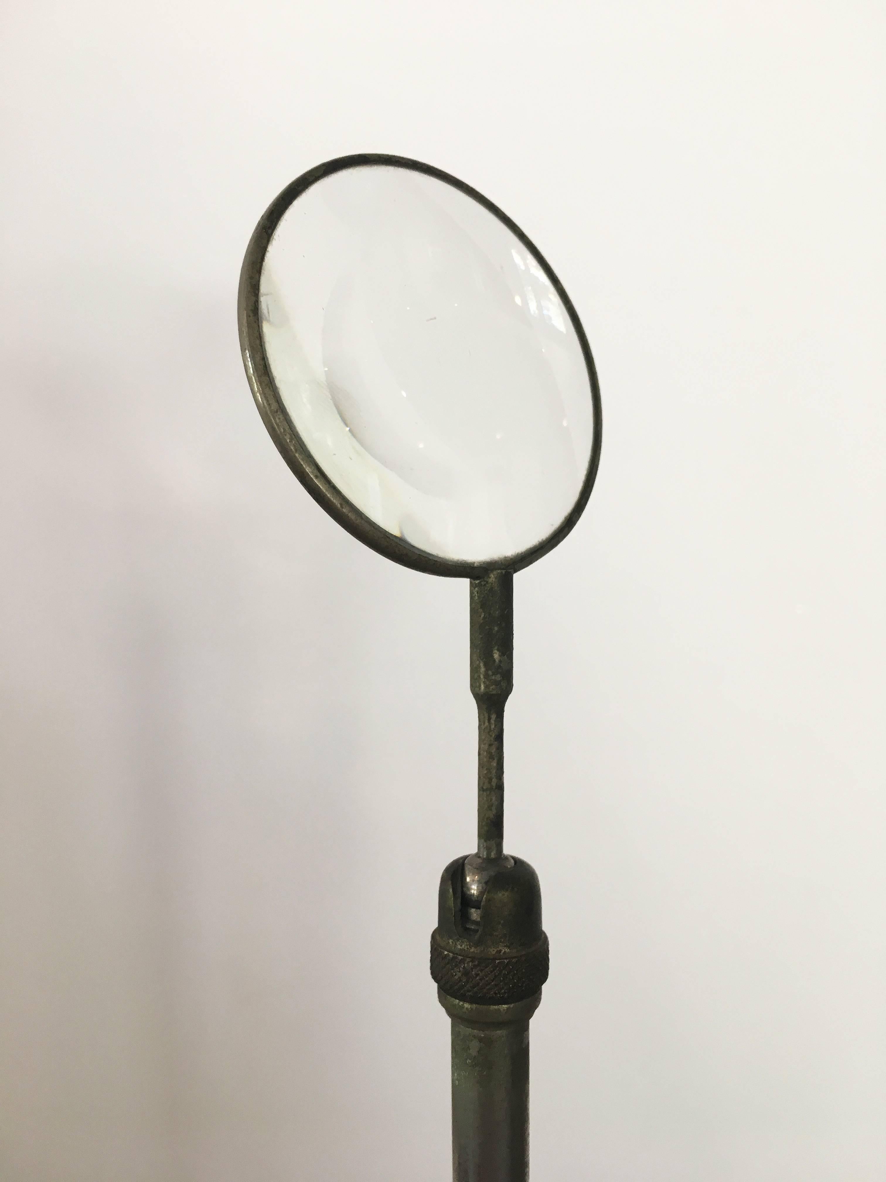 Freestanding vintage Victorian magnifying glass on a stand.