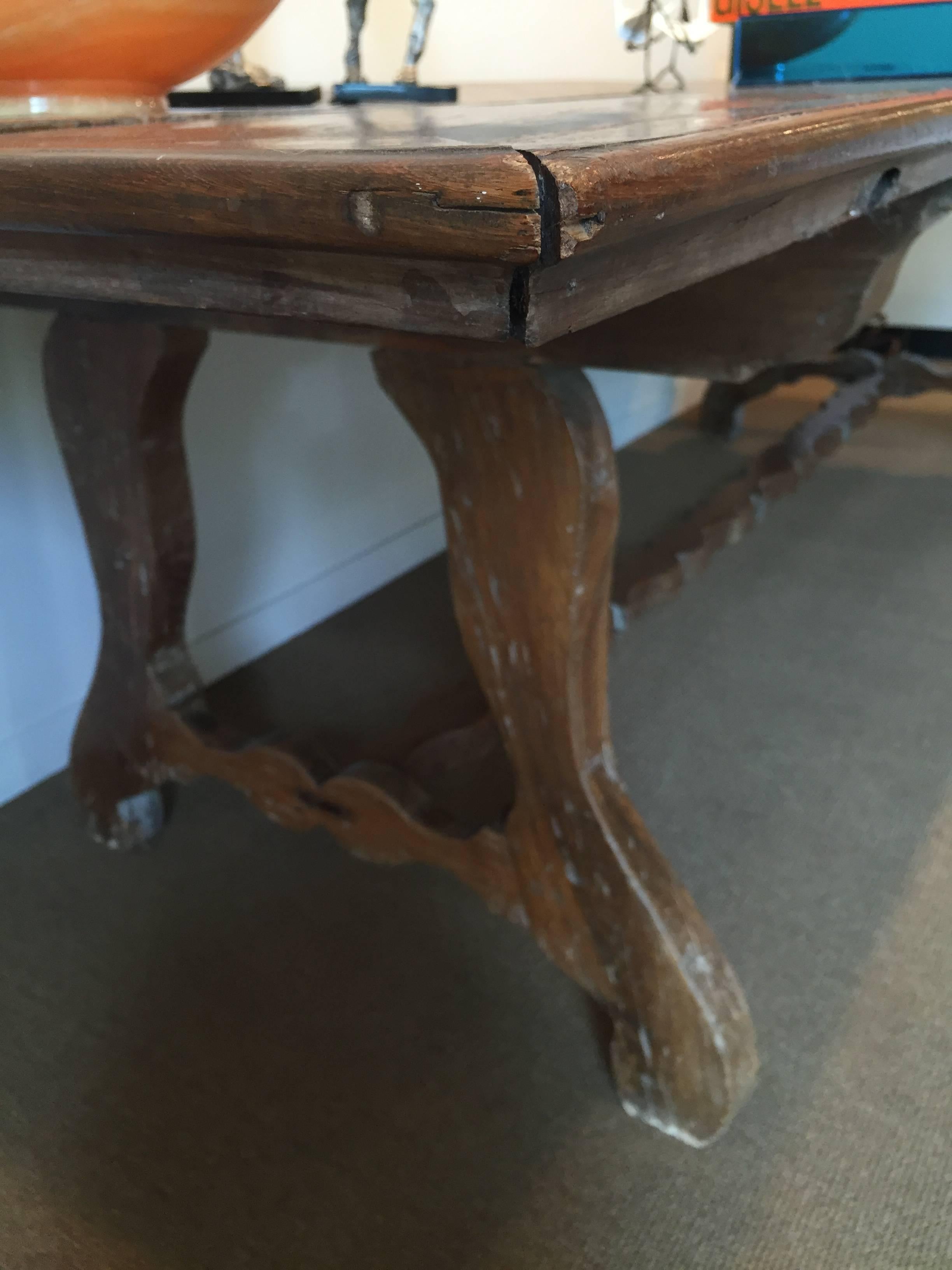 The rectangular top is raised on trestle legs joined by a baluster shaped stretcher. Vintage condition, see images.
