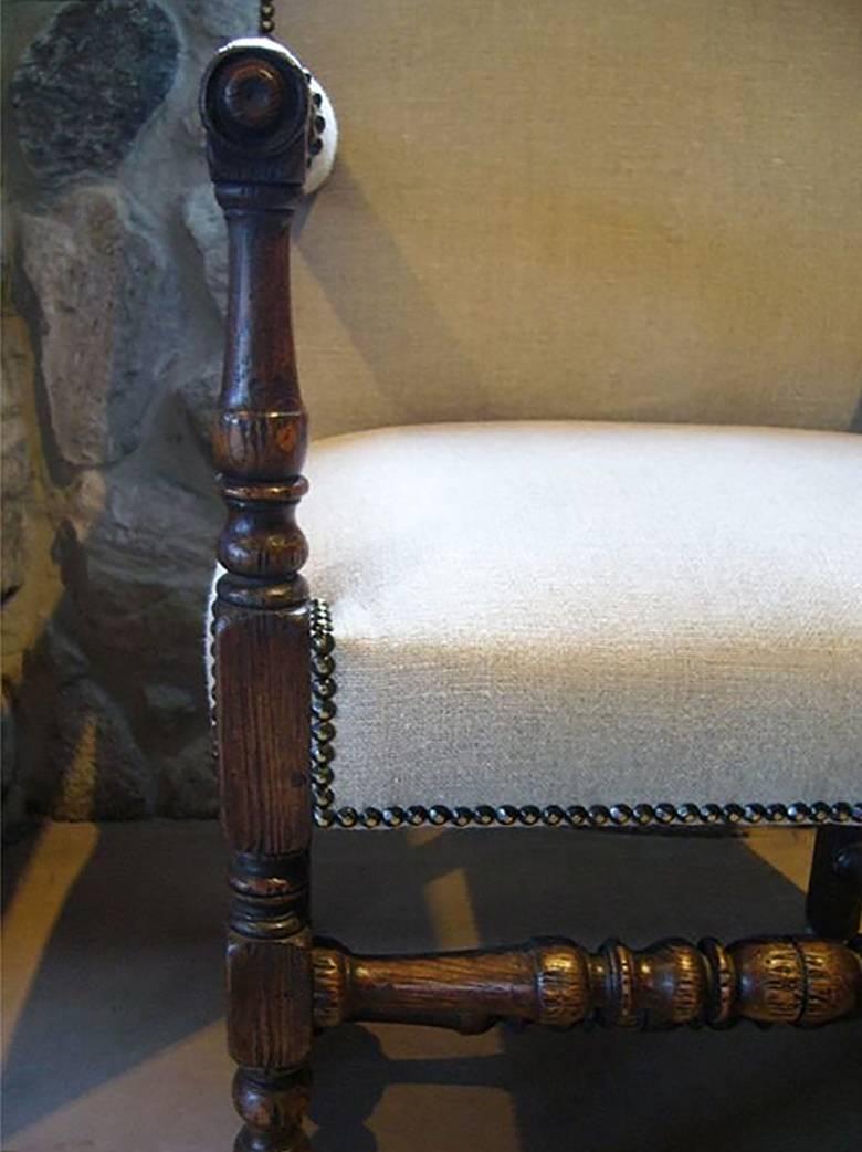 Upholstered armchair with turned legs and nailhead trim, circa 19th century, with turned legs in Renaissance style.

More recently upholstered in linen, please see images and inquire for more details.