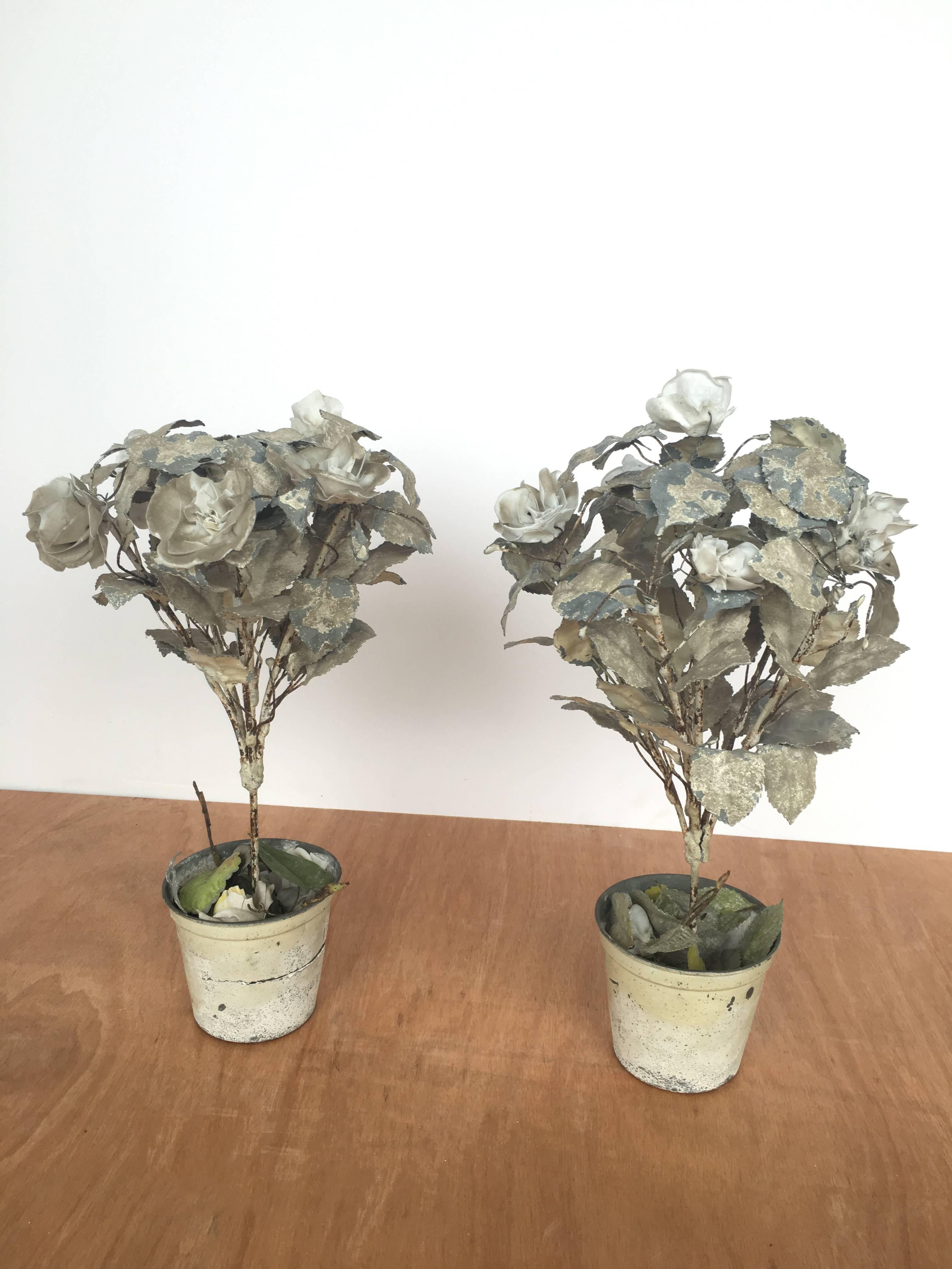 Pair of porcelain toile flower pots. Porcelain roses on a wire stem with flexible, painted metal petals. Each bouquet is rooted in a painted tin flower pot. 

Please review images for condition. 

Priced as a pair.