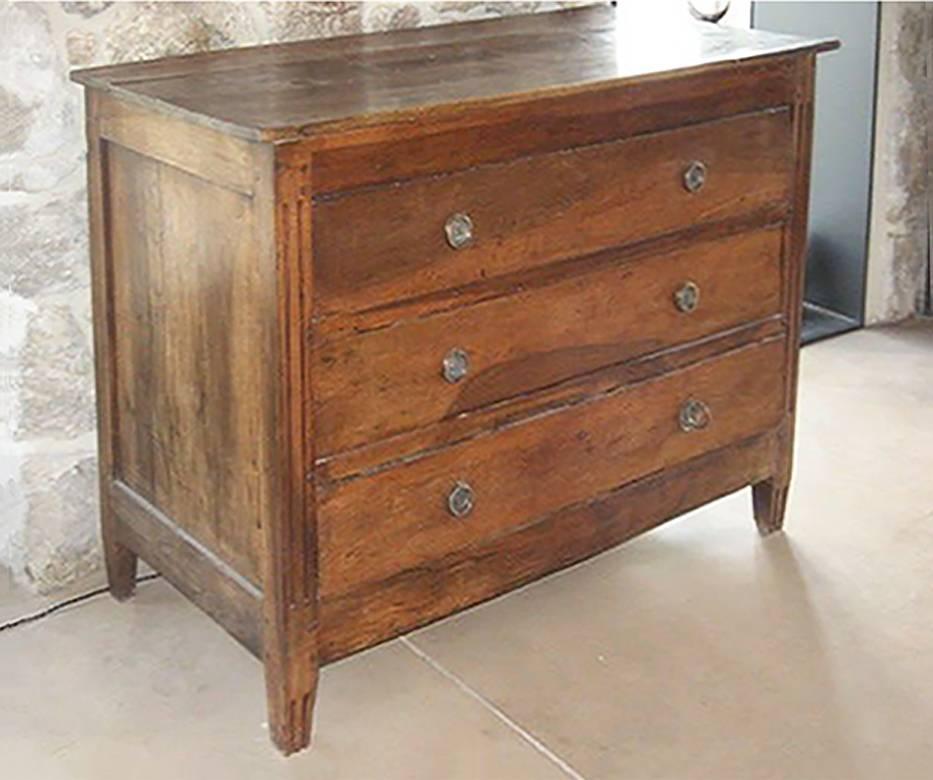Louis XVI Directoire commode from the late 18th Century. Walnut with three drawers with bronze circular hardware.
