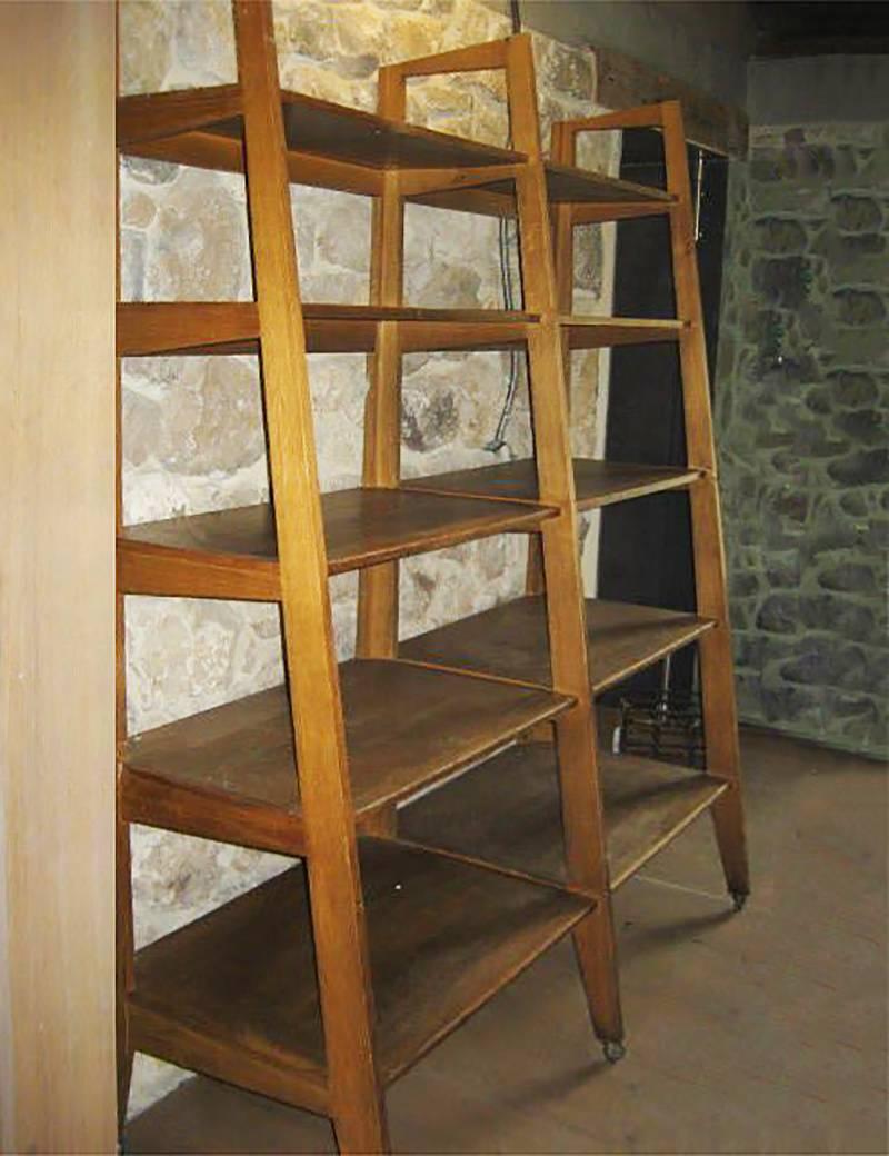 Vintage oak shelf with five tapering shelf tiers, Denmark, circa 1950. 

Depth of each shelf ranges to 27 inches. Comes with a set of metal casters.
    