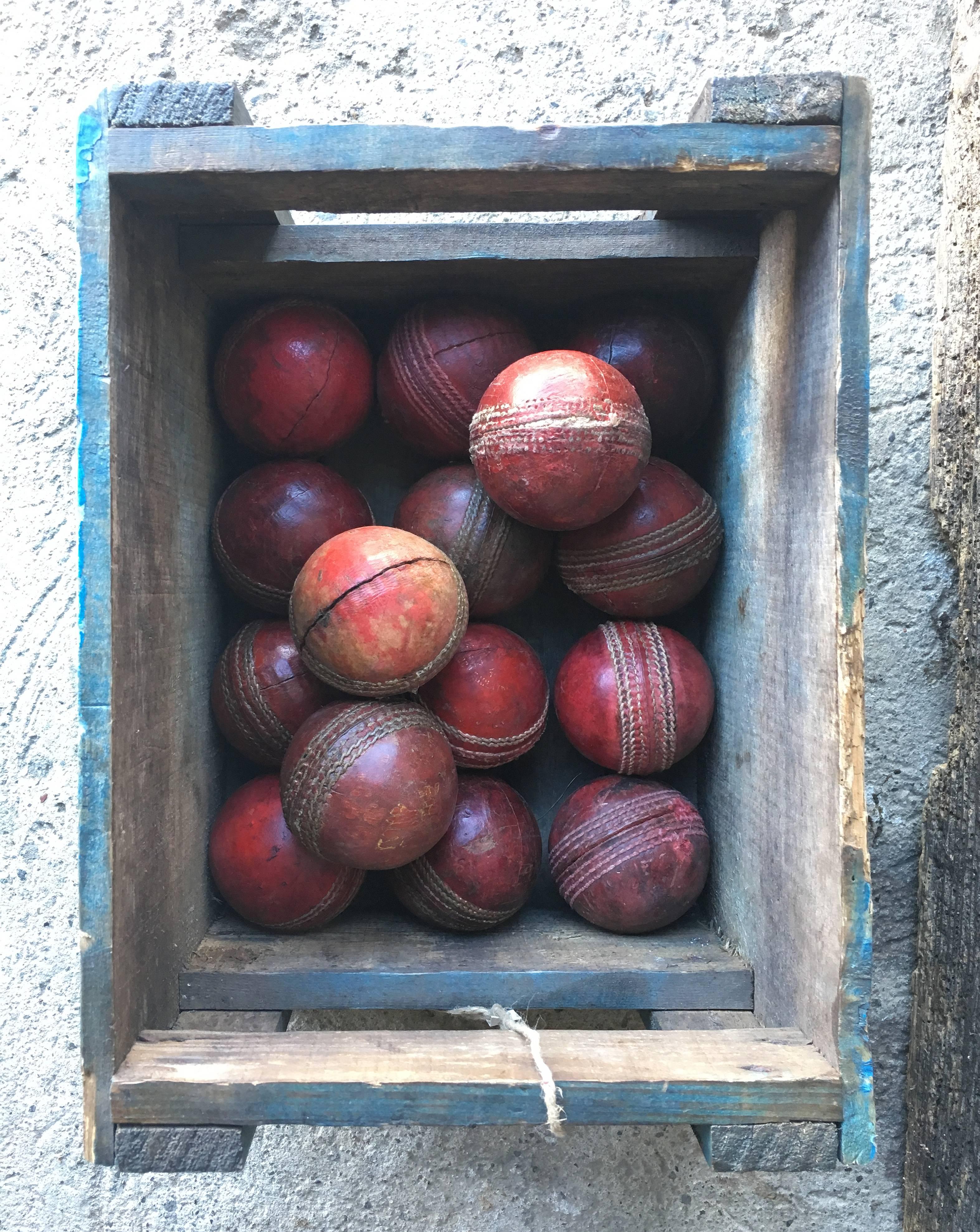 Set of 15 vintage red leather cricket balls, circa 1950s. 

Each ball approximately 3 inches in diameter, with unique shape and stitching details.

Please inquire regarding collecting a smaller selection of cricket balls. 