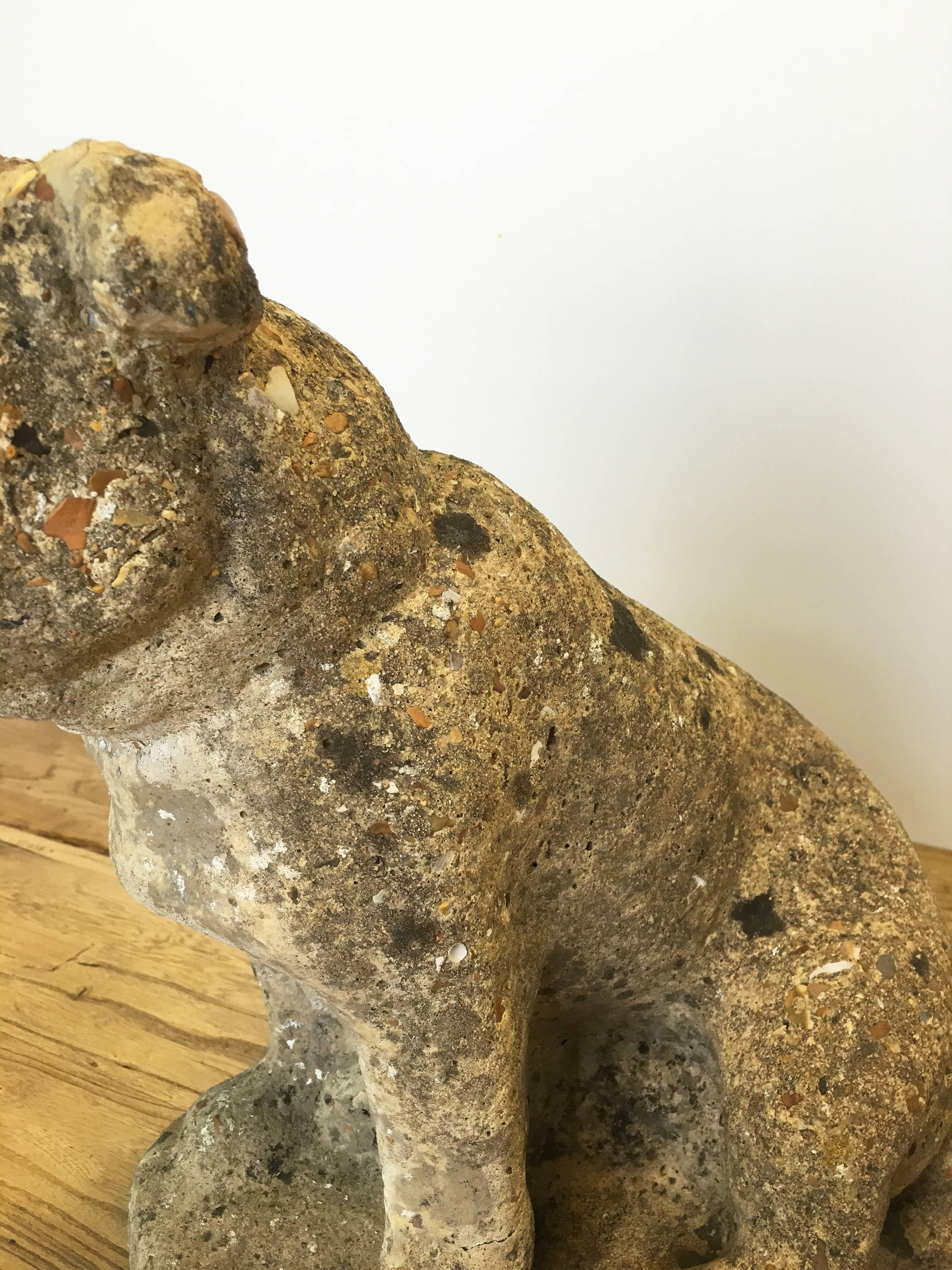 Vintage cast stone pug with one eye. Previously placed in a garden, with organic patina and spots of lichen. Minor wear consistent with age and use.