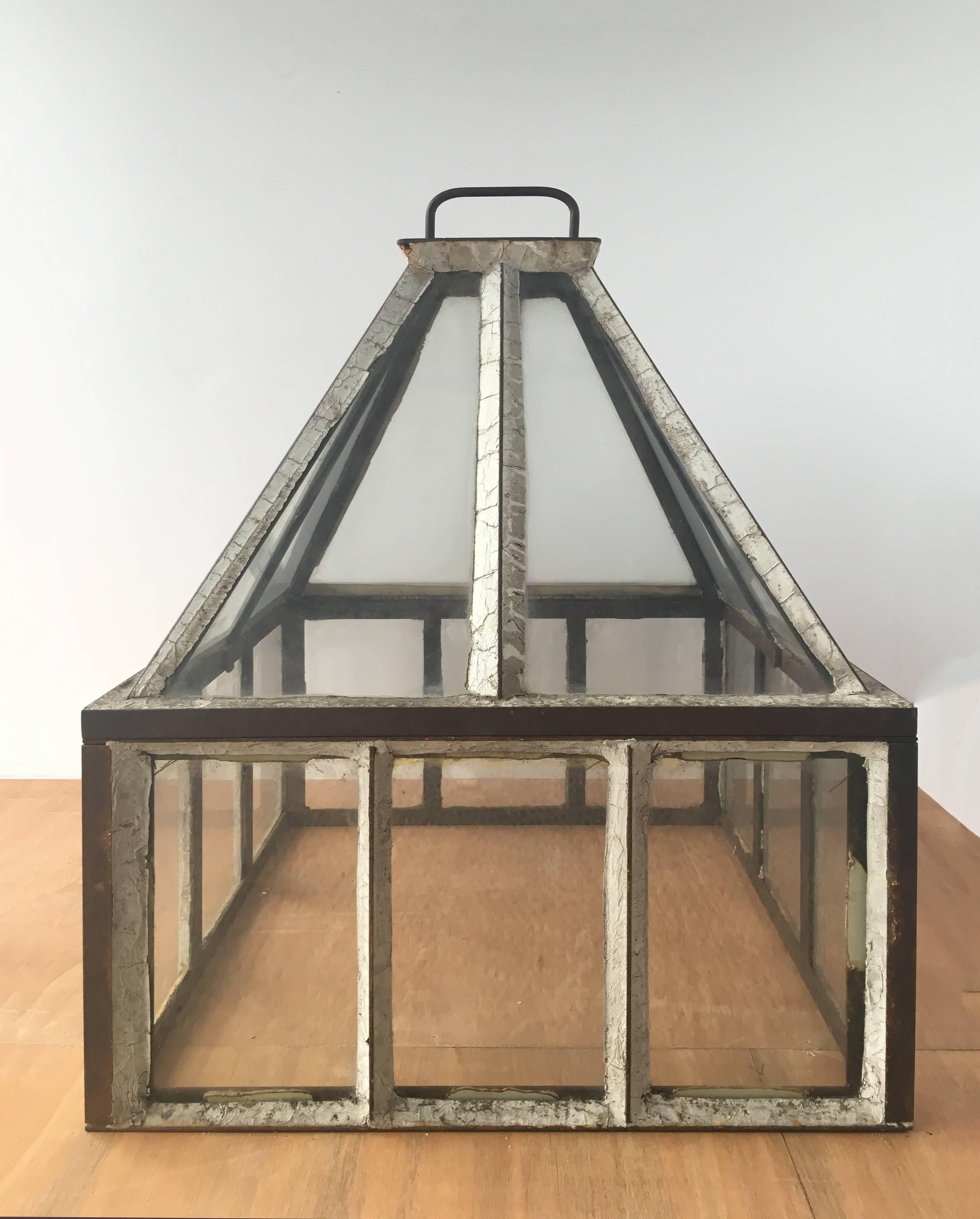 Beautiful, spacious glass houses.  Each terrarium has a handle on the top and come in two pieces, with the roof lifting off the walls.  These are vintage, elegant looking objects that inspire the imagination.  Sold separately.