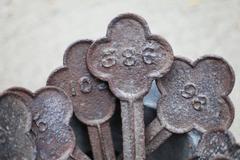 Set of Four Cast Iron Quatrefoil Numbered Grave Markers, 19th Century
