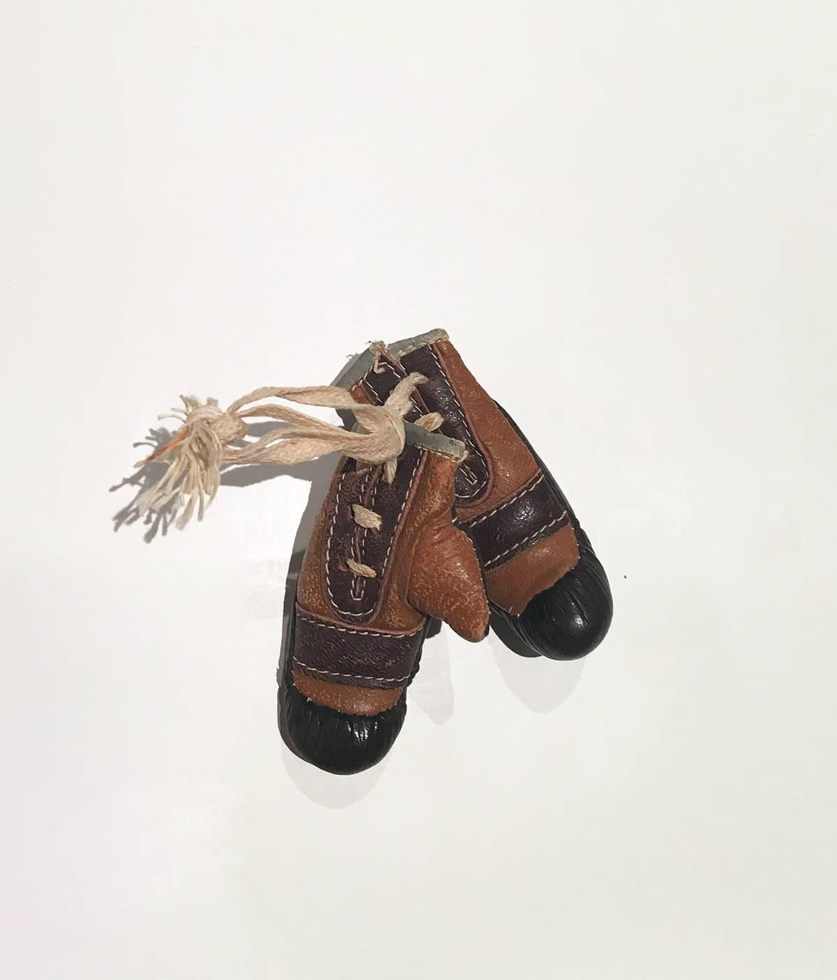 Paire de petits gants de boxe en cuir vintage. 

Cuir cousu avec un lacet les attachant ensemble ; pourrait être réutilisé pour un porte-clés ou un porte-clés.