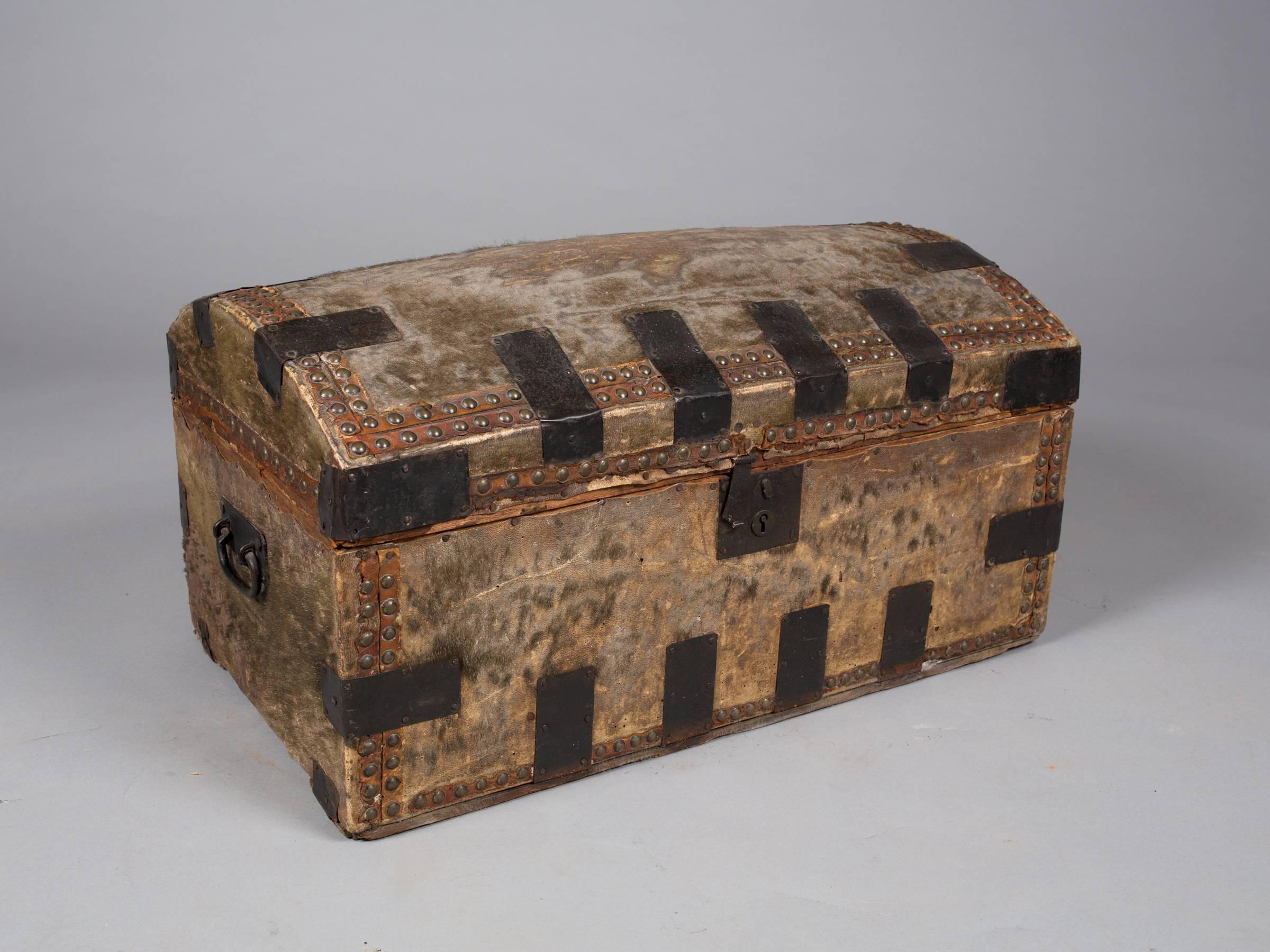 Handsome collection of 19th century leather and hair on hide trunks and boxes with original interior paper linings. Newspaper lining on smaller dark trunk dated March 20th, 1824. Beautiful age and patina. Please see condition details. 
Large trunk