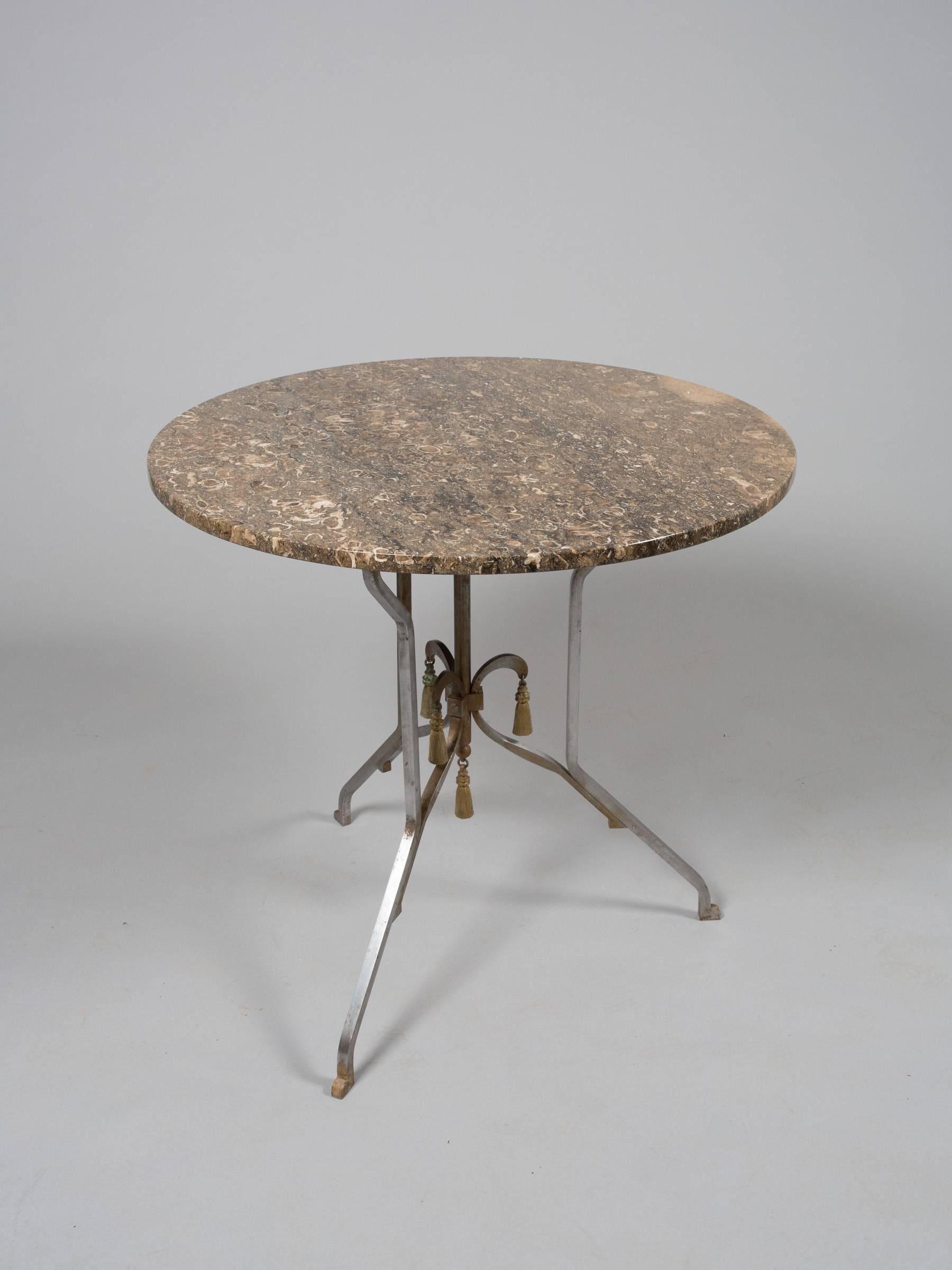 Elegant round steel occasional table with gold accents and variegated brown marble top. Attributed to Jansen.
