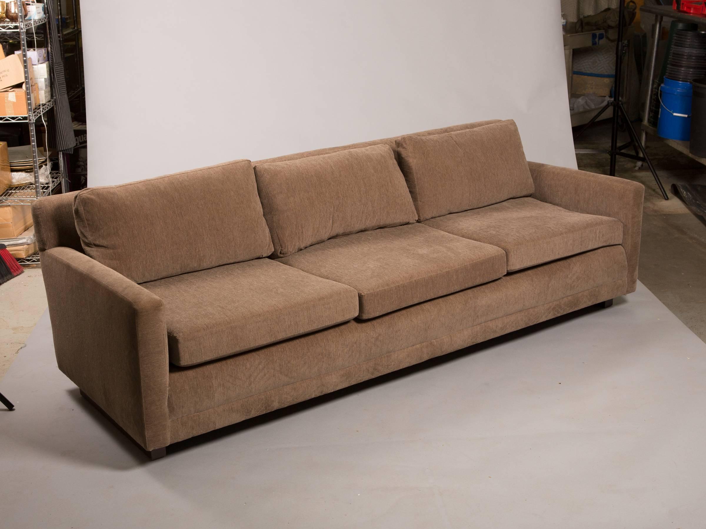 Mid-Century Modern couch with clean angular lines. Newly upholstered in a soft brown grey corduroy fabric with three taupe taffeta pillows.
Measures: Seat height 17