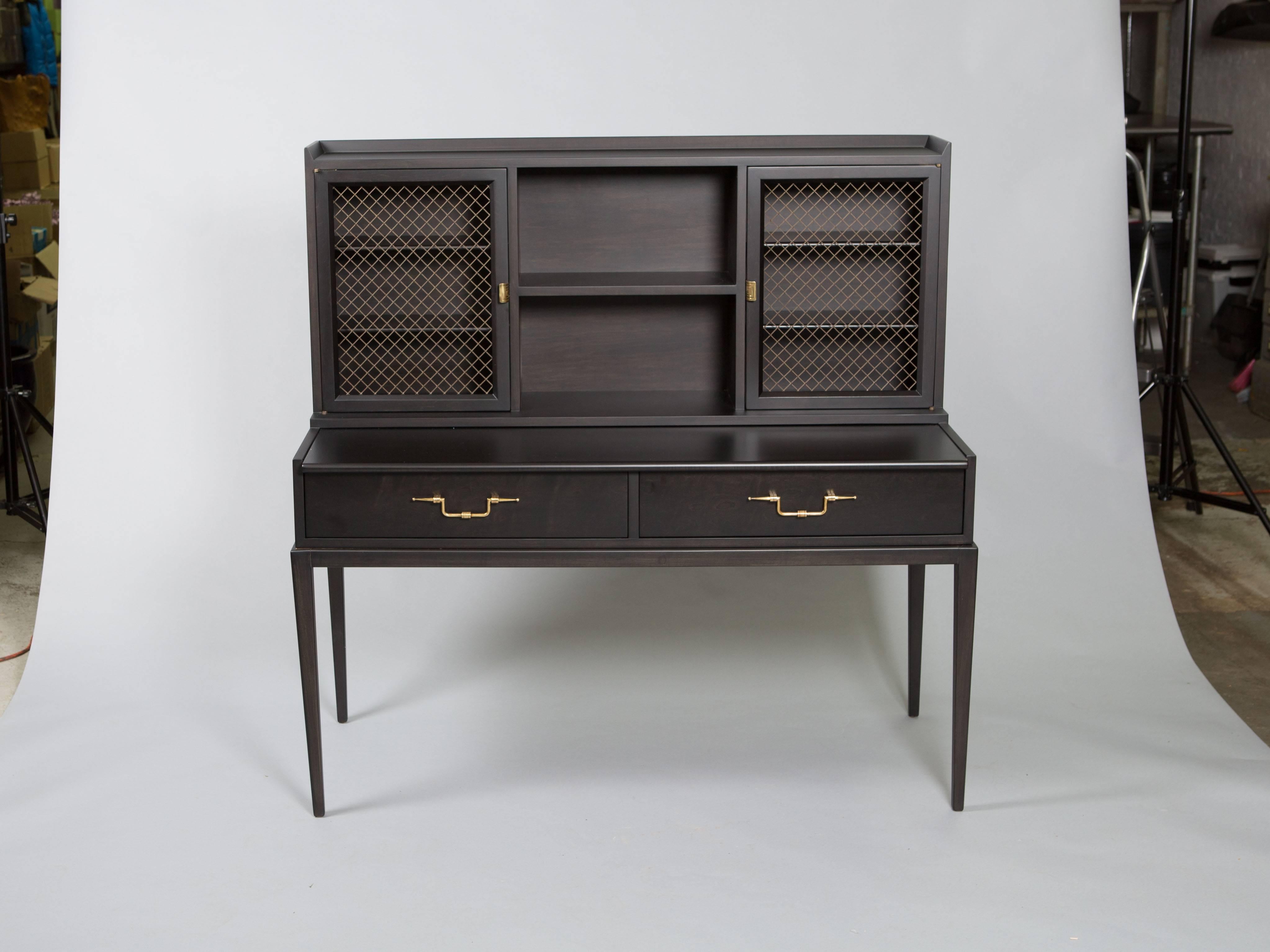 Tommi Parizinger secretary/desk with metal grill doors, brass hardware and tapered legs. Stamped on the inside of drawer. Beautiful restored condition.
Desk depth - 11