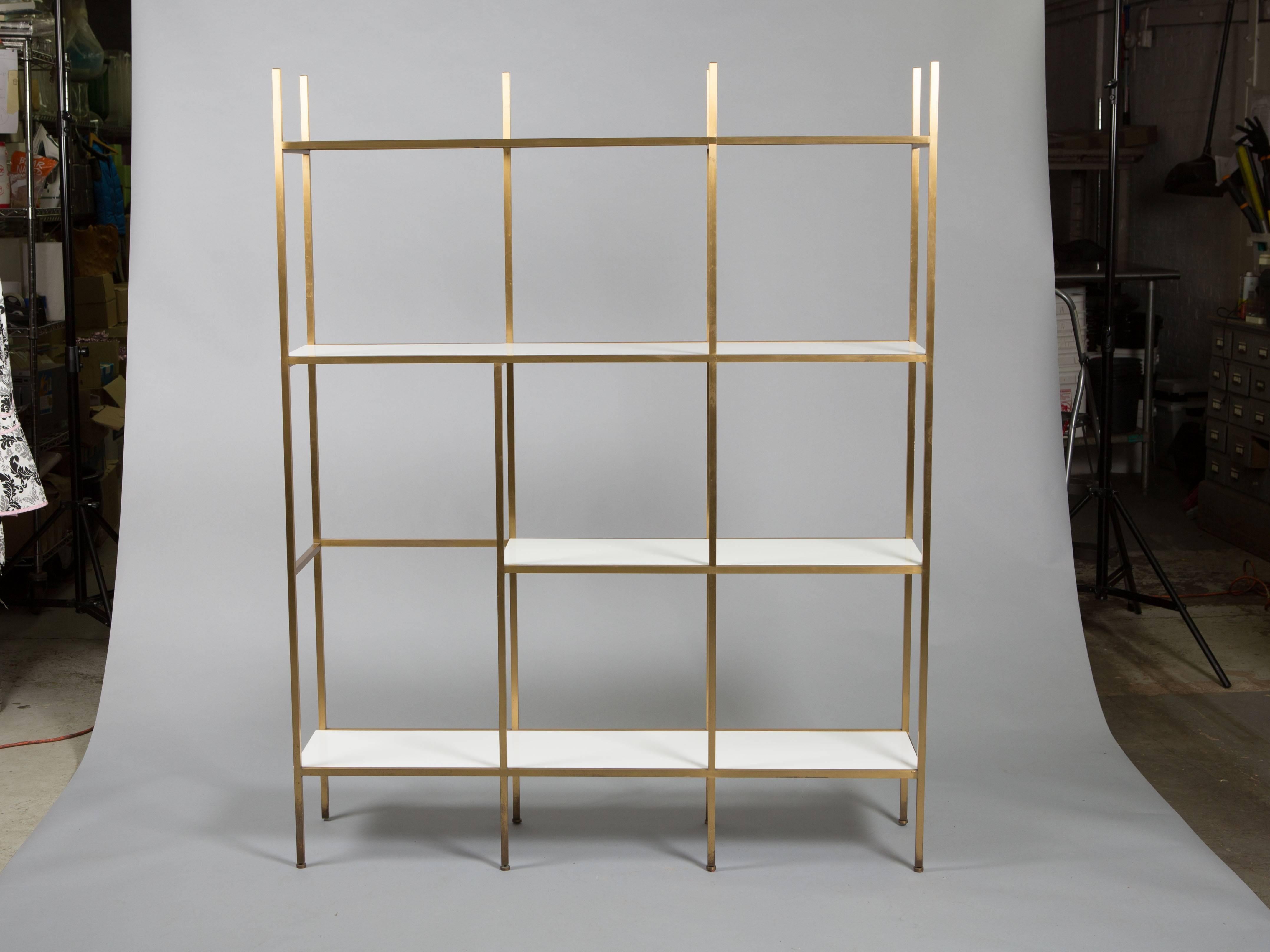 Paul McCobb brass etagere or shelving unit with geometric design and glass shelves. Metal has a wonder patina to the legs. 
17.5