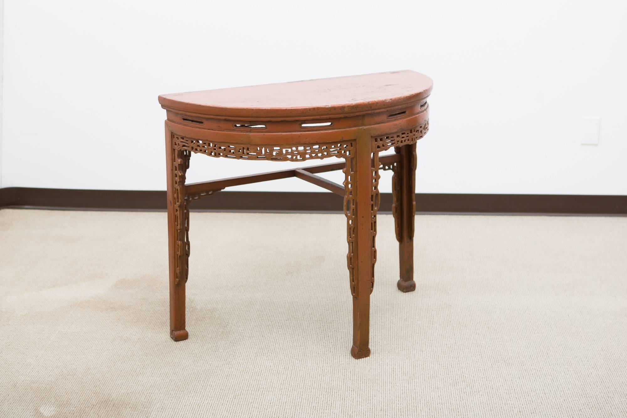 Painted 19th century, Chinese demilune console with three legs and great carved detailing on legs and apron.