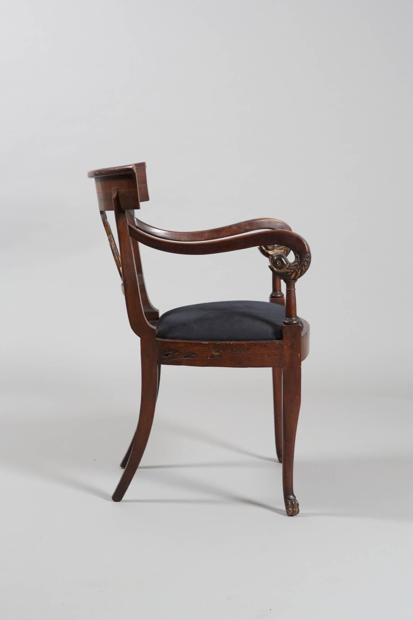 Beautifully carved Directoire style armchair with gilded details on arms, feet and back. Carved backrest with carved swan detail. Very handsome piece!
Measures: 18