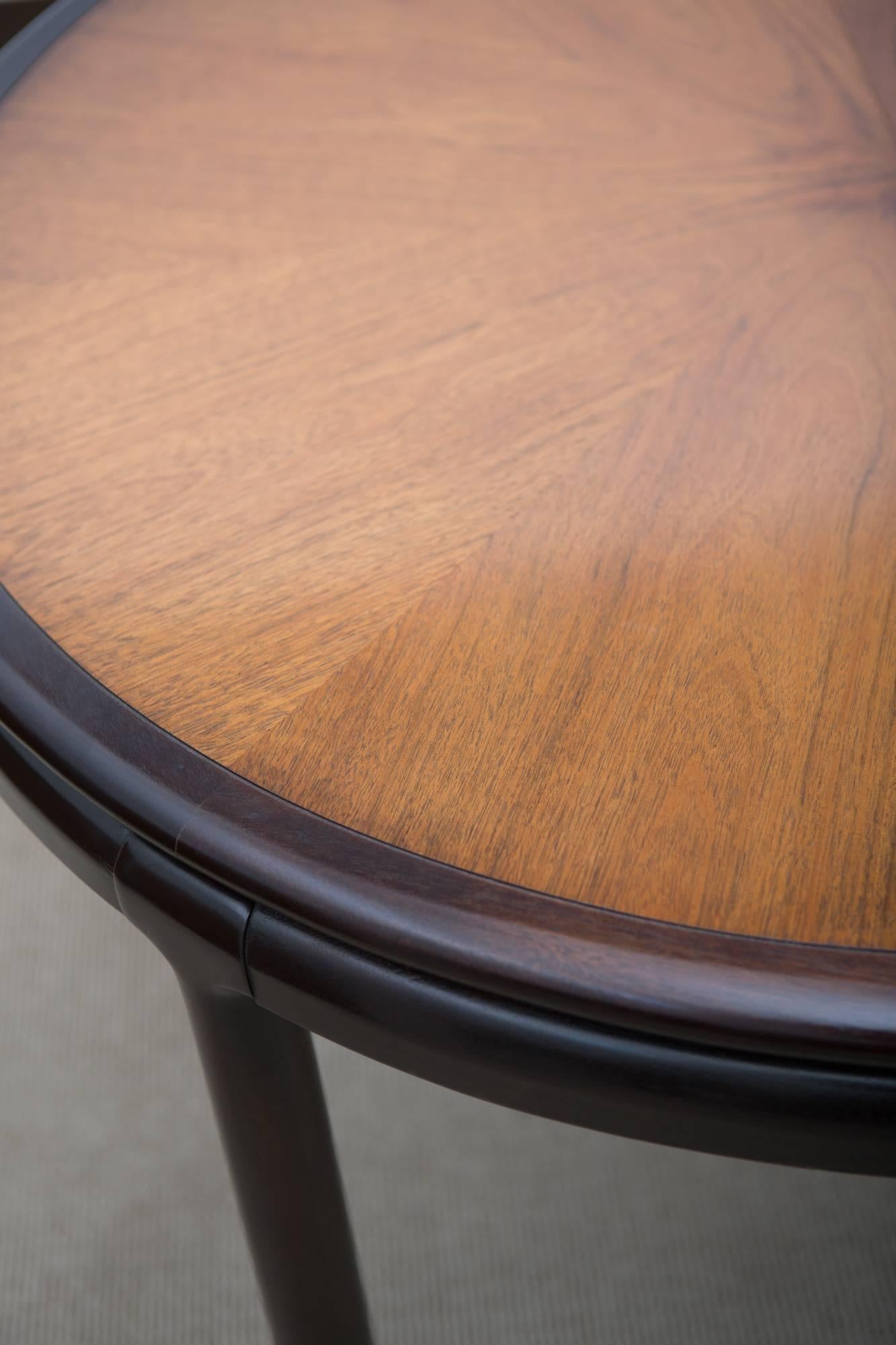 1970s ebonized dining table with two leaves and brass feet. Has a protective tabletop cover. Great original condition!
Leaves measure 24