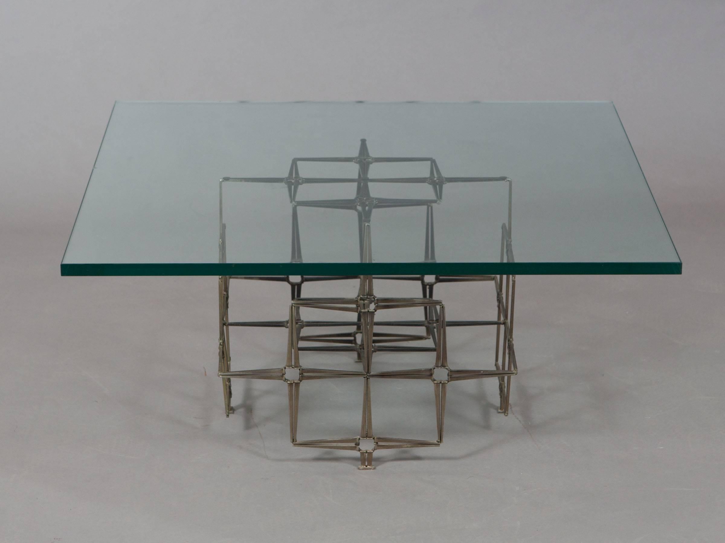 Handcrafted table constructed of welded steel masonry nails with a thick glass top in the style of Paul Evans. Geometrically sculpted base features a beautiful patina. Base measures 18.75