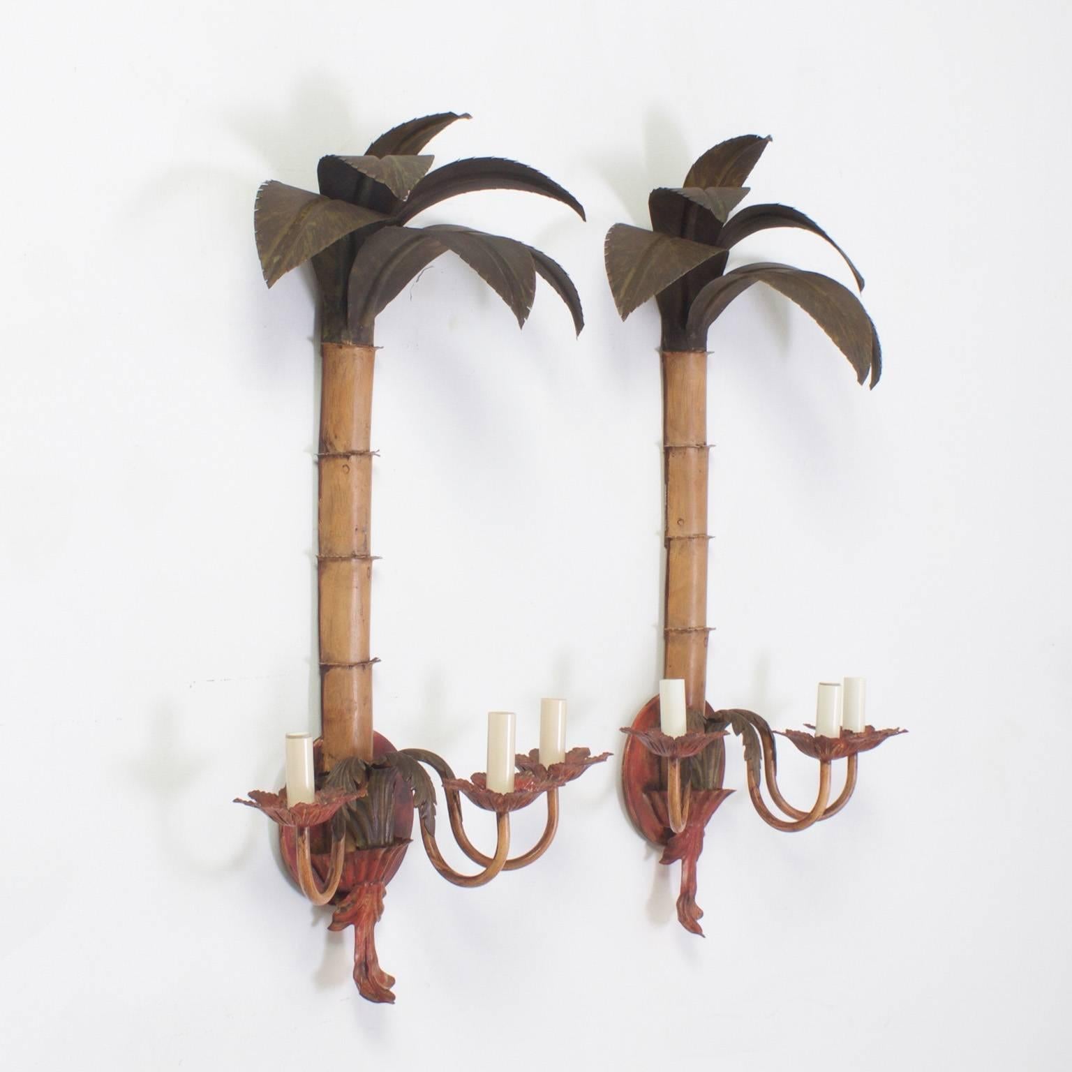 Pair of Mid-Century stylized three-light tole sconces, handcrafted and decorated with muted Mediterranean colors. Perfect for tropical, island or coastal living, or any interior that deserves a bit of whimsy. Newly wired.
Please check out our other