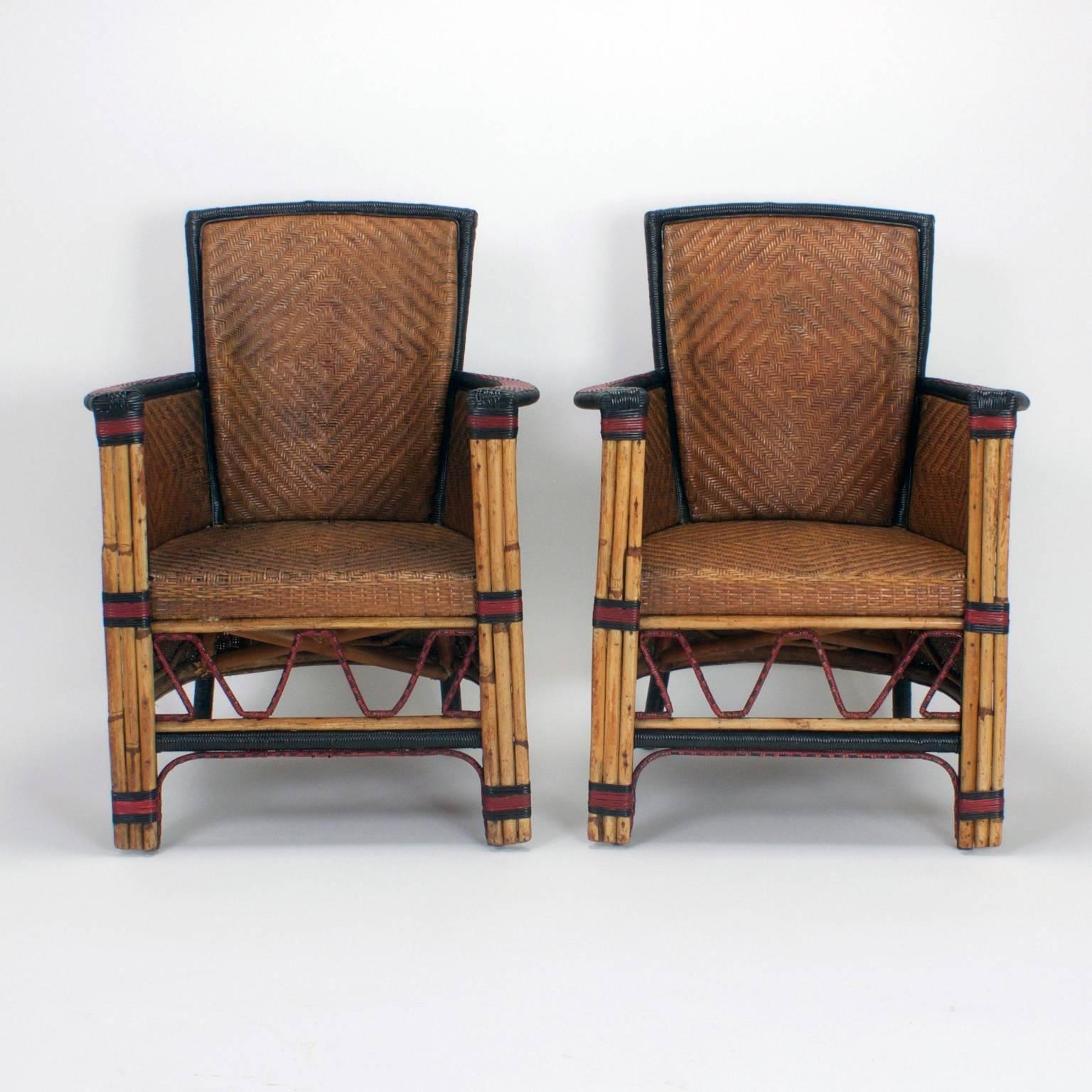 Rare and possibly the only pair of armchairs of this type. These chairs are crafted with wicker, reed, and bamboo. These stylish Art Deco type chairs have a strong 