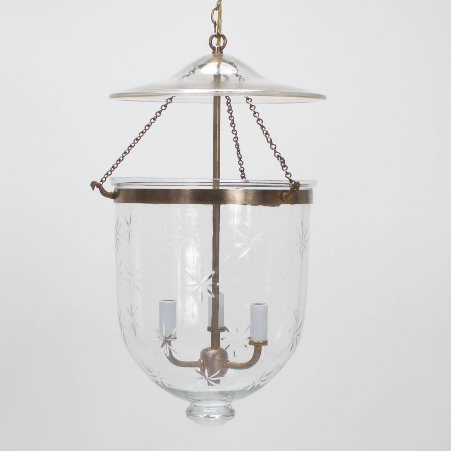 Smoke bell jar lantern or light fixture composed of burnished brass and handblown glass with cut stars that will put an extra twinkle in your night. This spirited pendants has a traditional form that still seems fresh today.

   