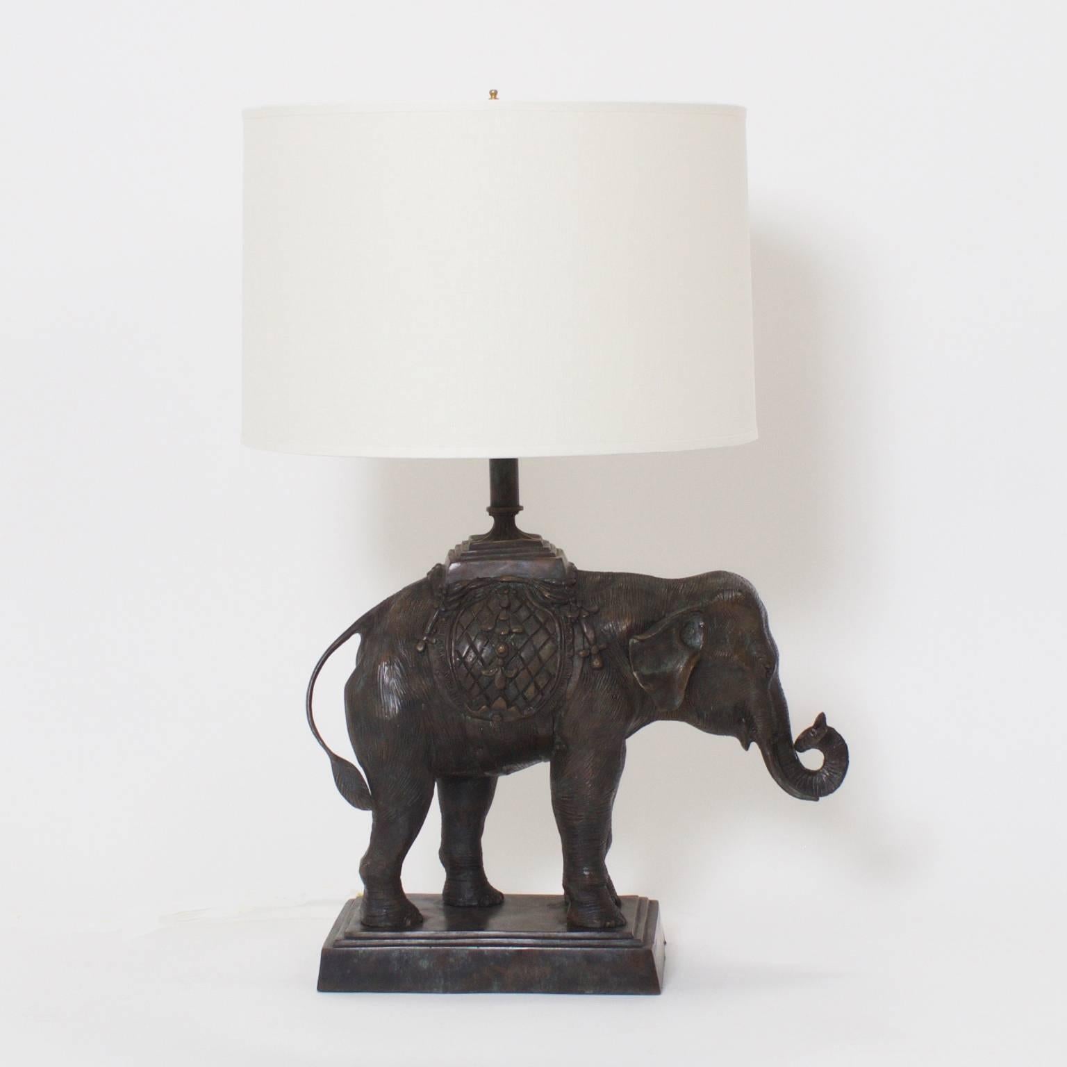 Handsome pair of cast bronze table lamps depicting India elephants wearing traditional garments. Probably Maitland-Smith, these impressive lamps have an old world patina and a strong stately presence. Newly wired.