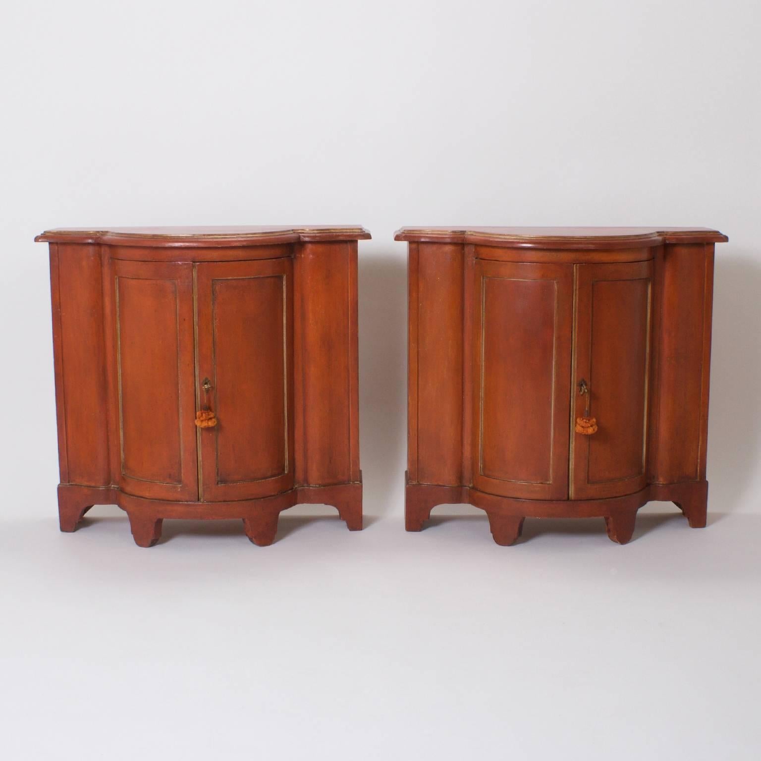 It would be easy to fall in love with this pair of Italian cabinets with their exaggerated serpentine form and uniquely continental rusty orange color. These servers are understated from top to bottom which highlights their perfect proportions. Both