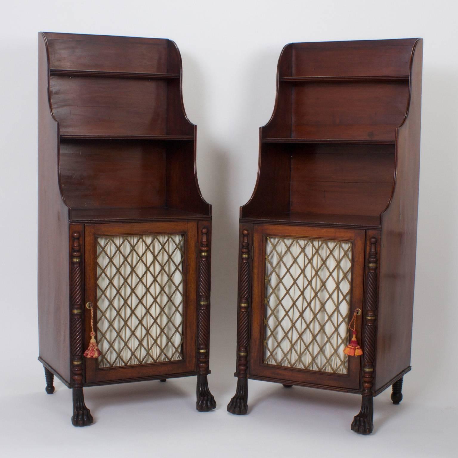 Rare pair of traditional Irish chiffoniers or sideboards crafted with mahogany and celebrating several early 19th century styles, including empire and regency. Featuring high quality brass metal work and carved columns with Egyptian revival cats paw