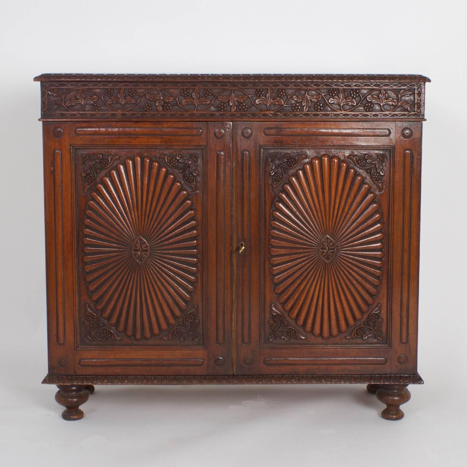 The pair of antique, Anglo-Indian servers, sideboards or cabinets that inspire admiration. Expertly crafted with tropical rosewood and carved with a confident, artistic hand. Featuring inset white marble tops with a pale grey grain, egg, and dart