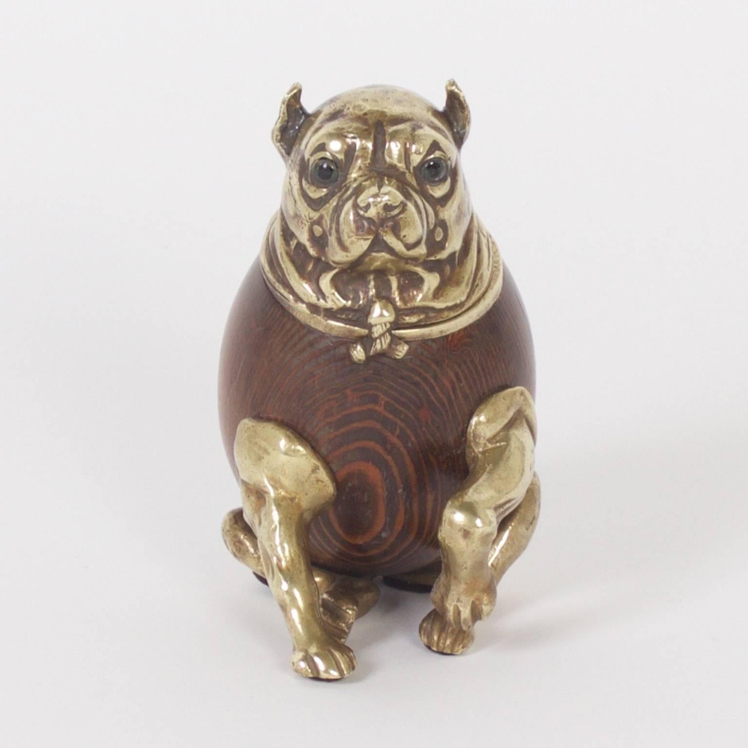 Humorous Mid-Century dog that is a hinged box. Crafted with cast brass and turned wood with glass eyes. This plump canine could be a pug or a bulldog and is ready to give his paw. Signed 